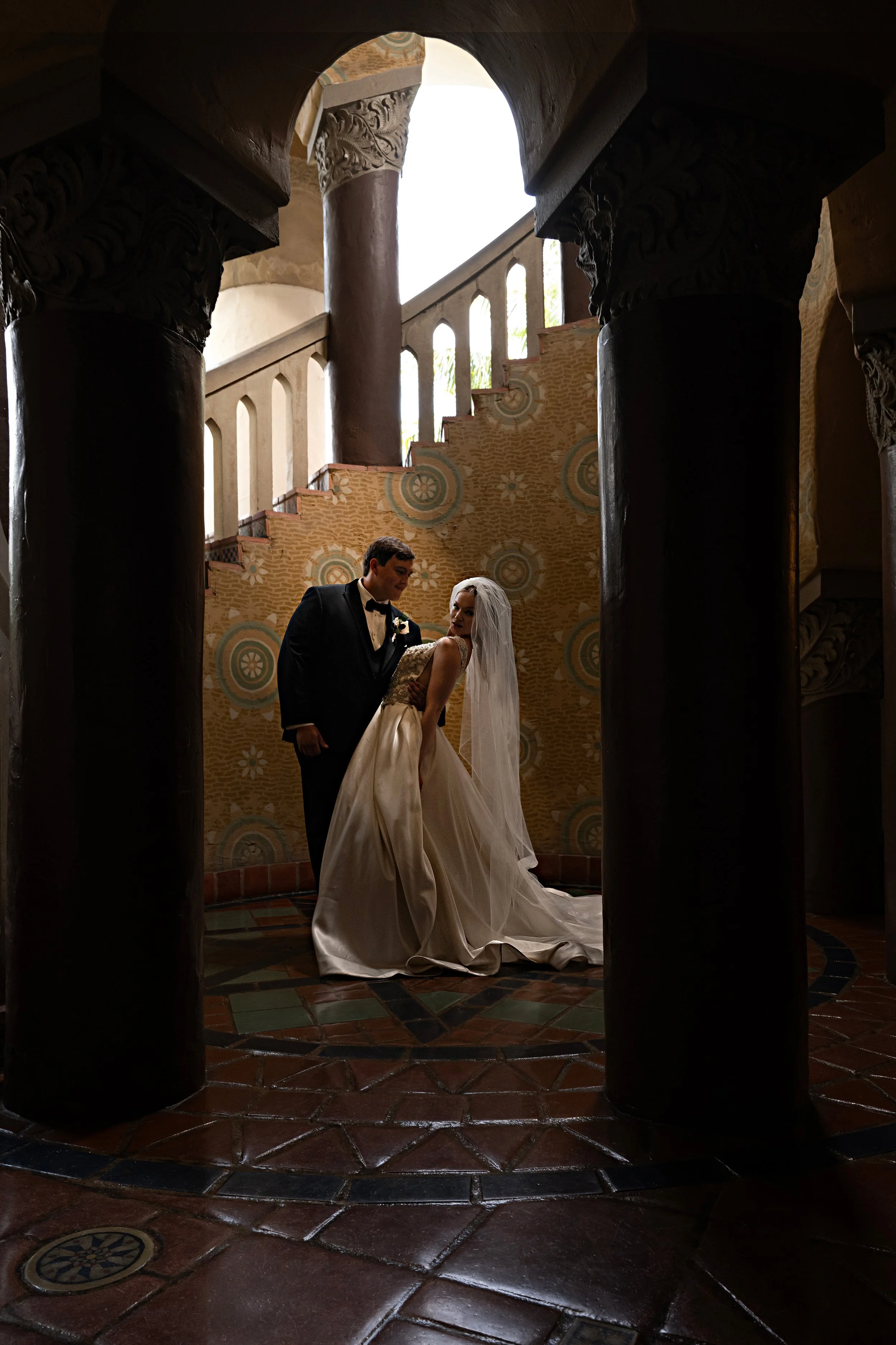 Portrait of the bride and groom by the spiral staircase