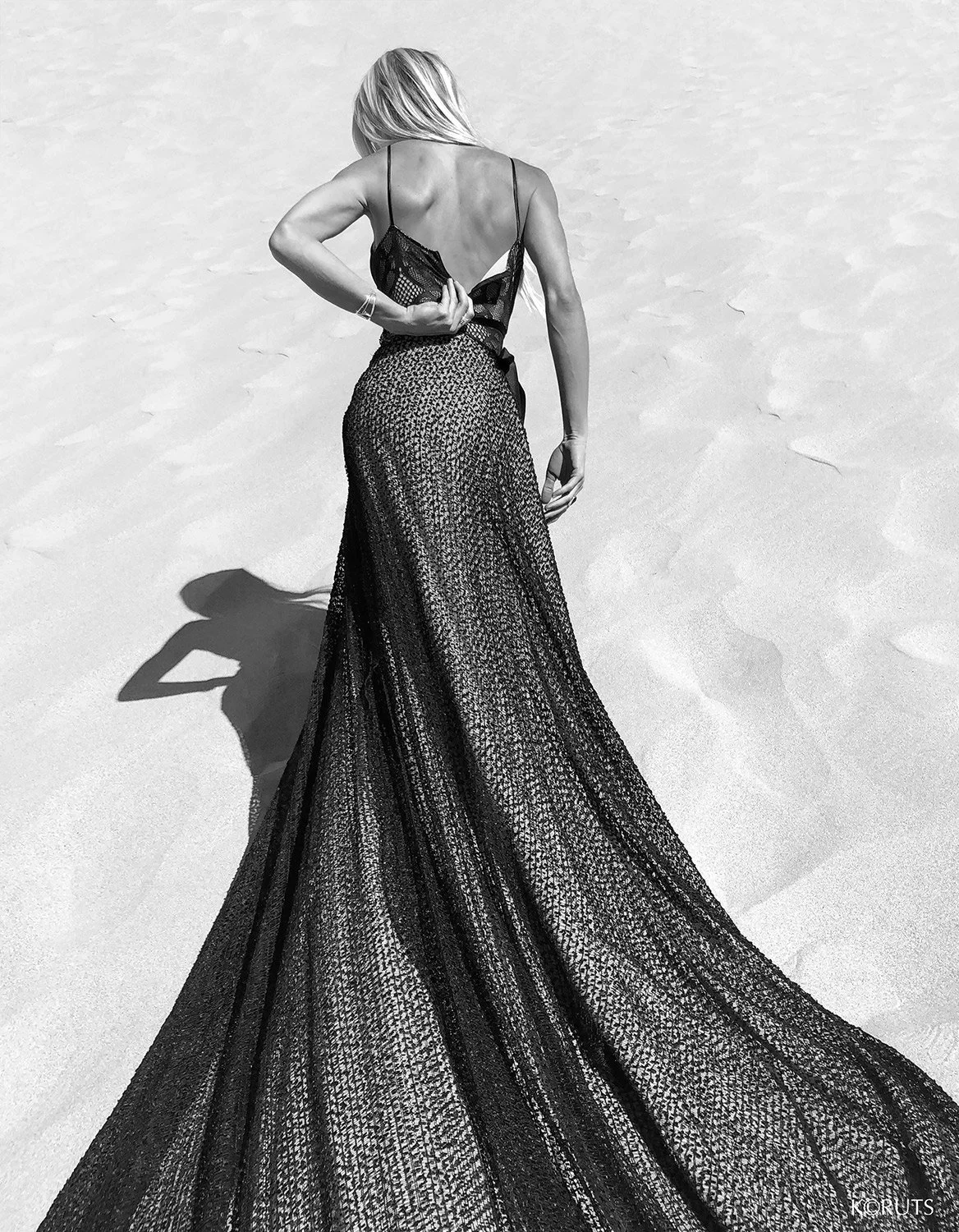 a fit model unzips her gown in the dunes