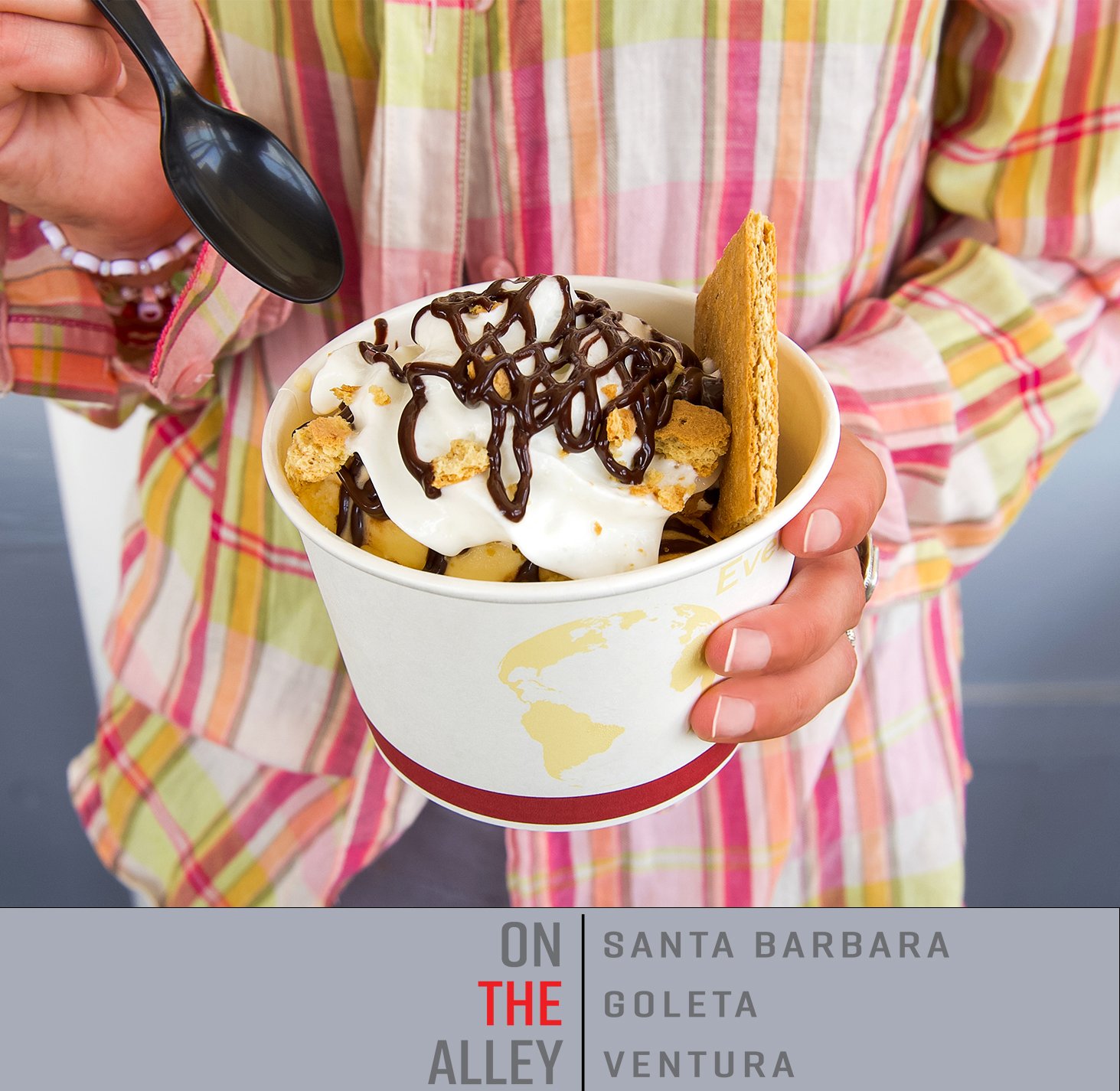 A woman in a summery blouse eats a dessert at On the Alley Ventura