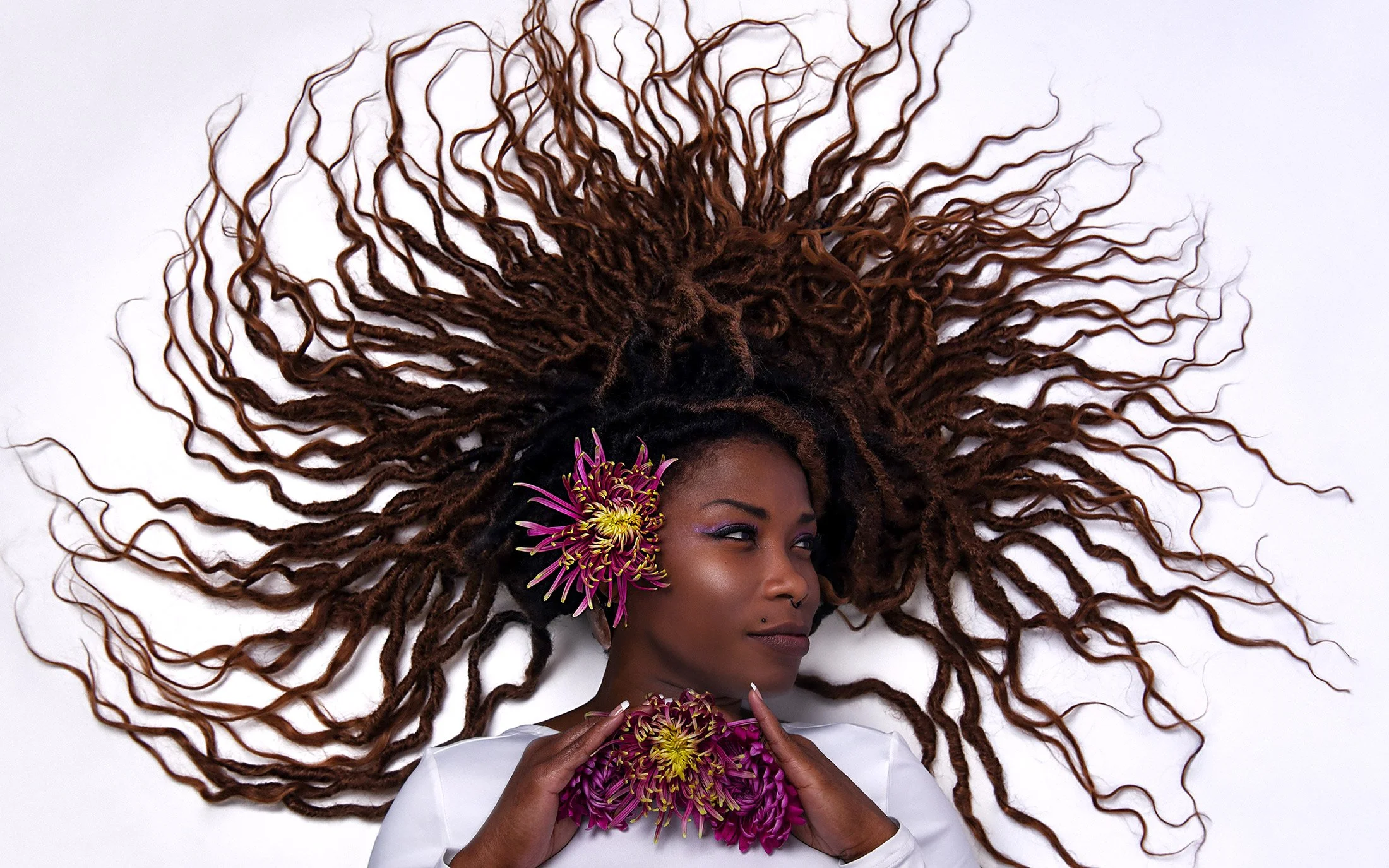 Creative studio portrait of female brown skin model in bold lighting