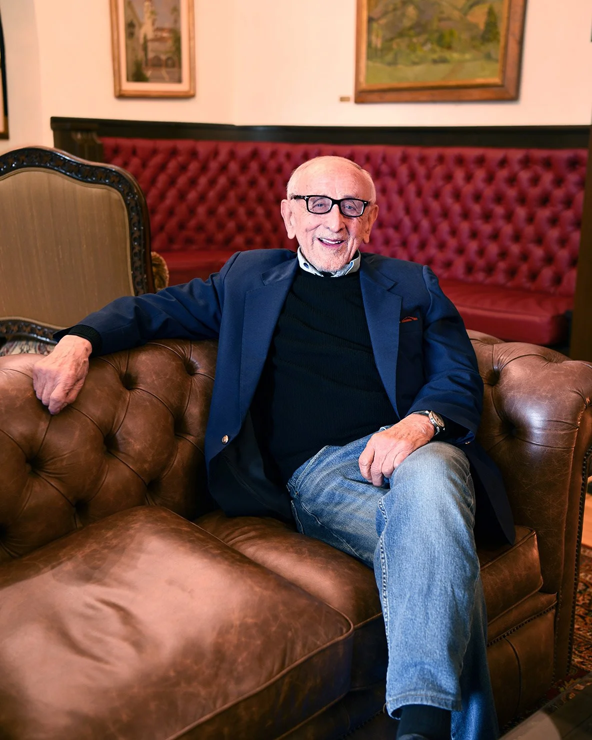Casual yet professional male portrait of author in relaxed setting.