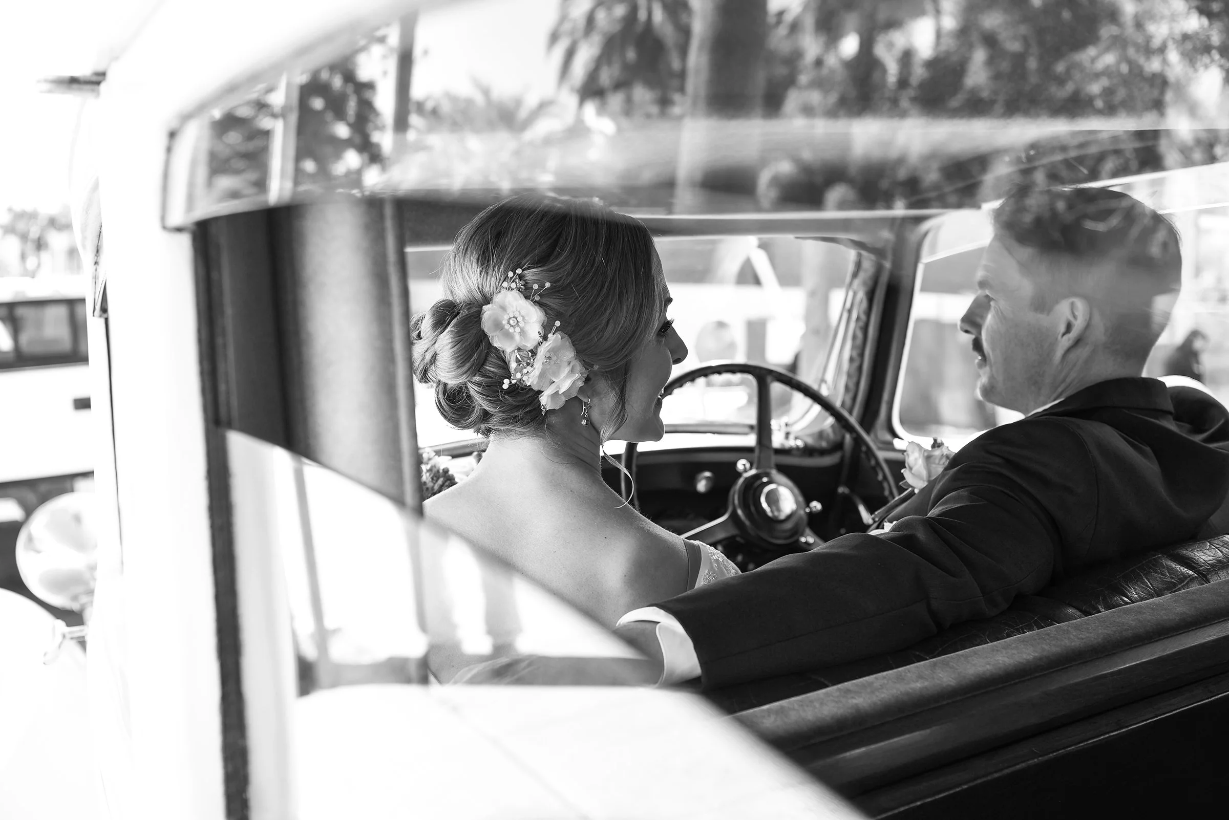 Newly weds drive off in a vintage Rolls Royce from the Historic Court house in Santa Barbara