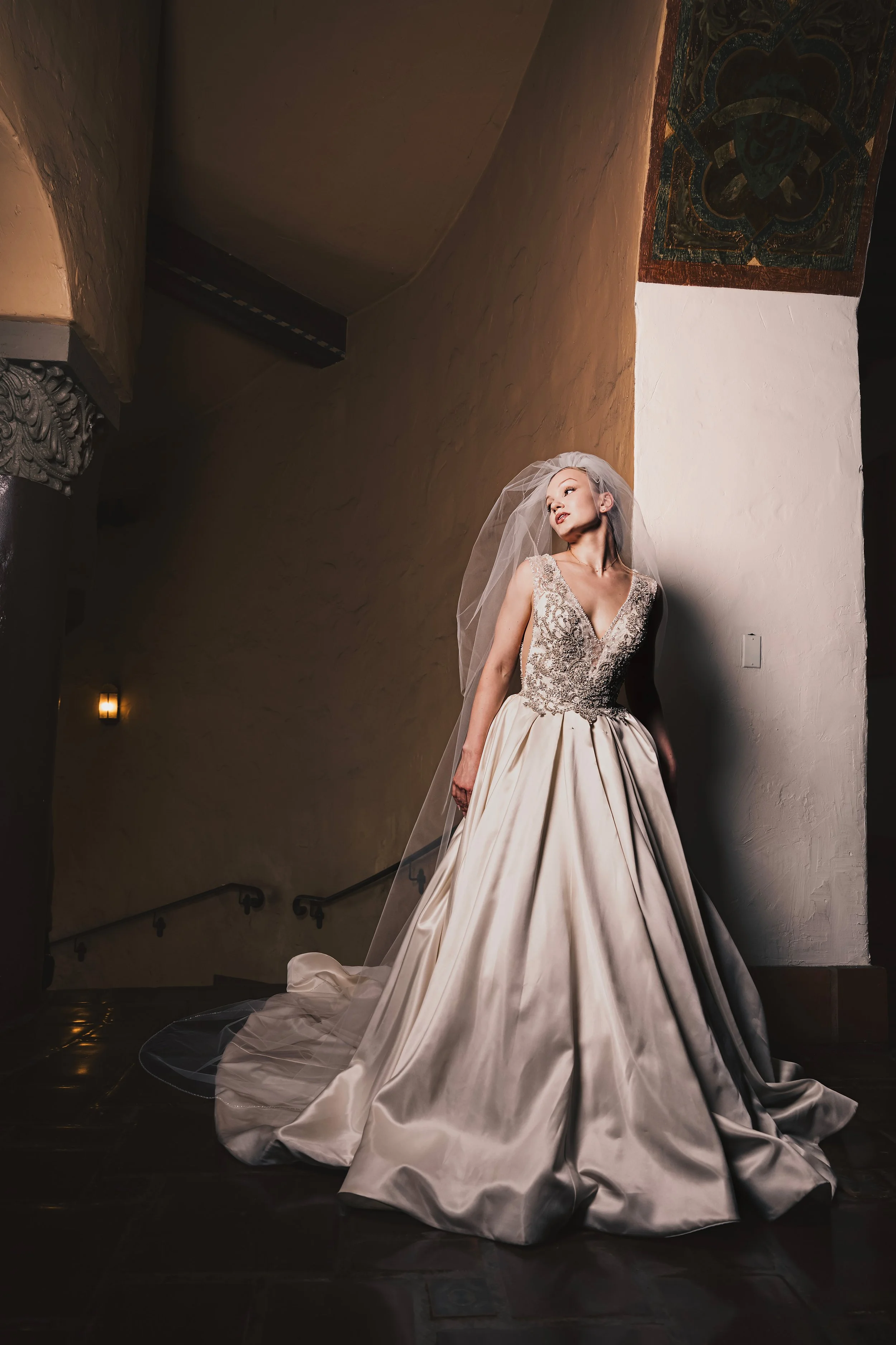 The bride in a dramatic pose in her couture wedding gown