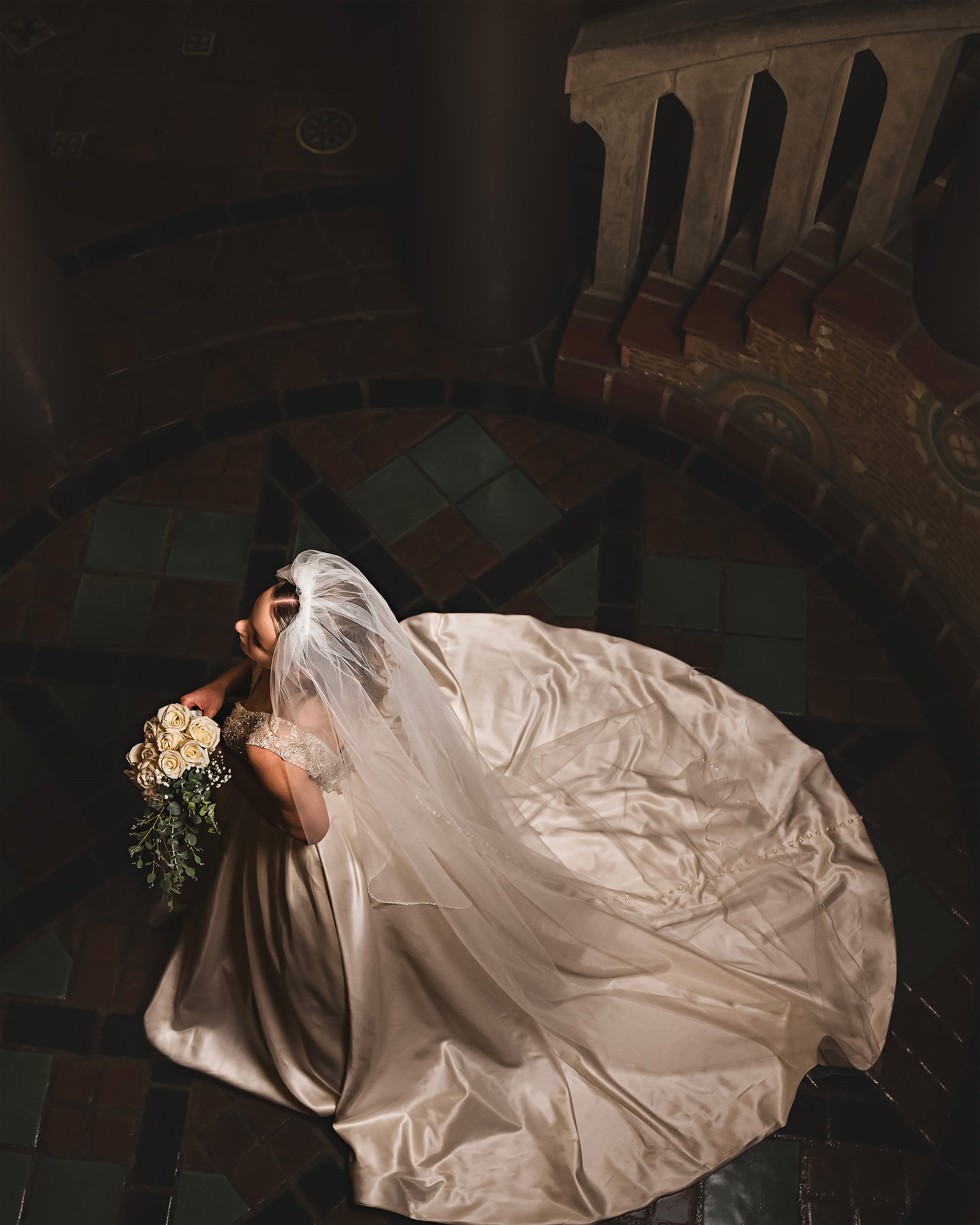 The gown of the bride cascades behind her