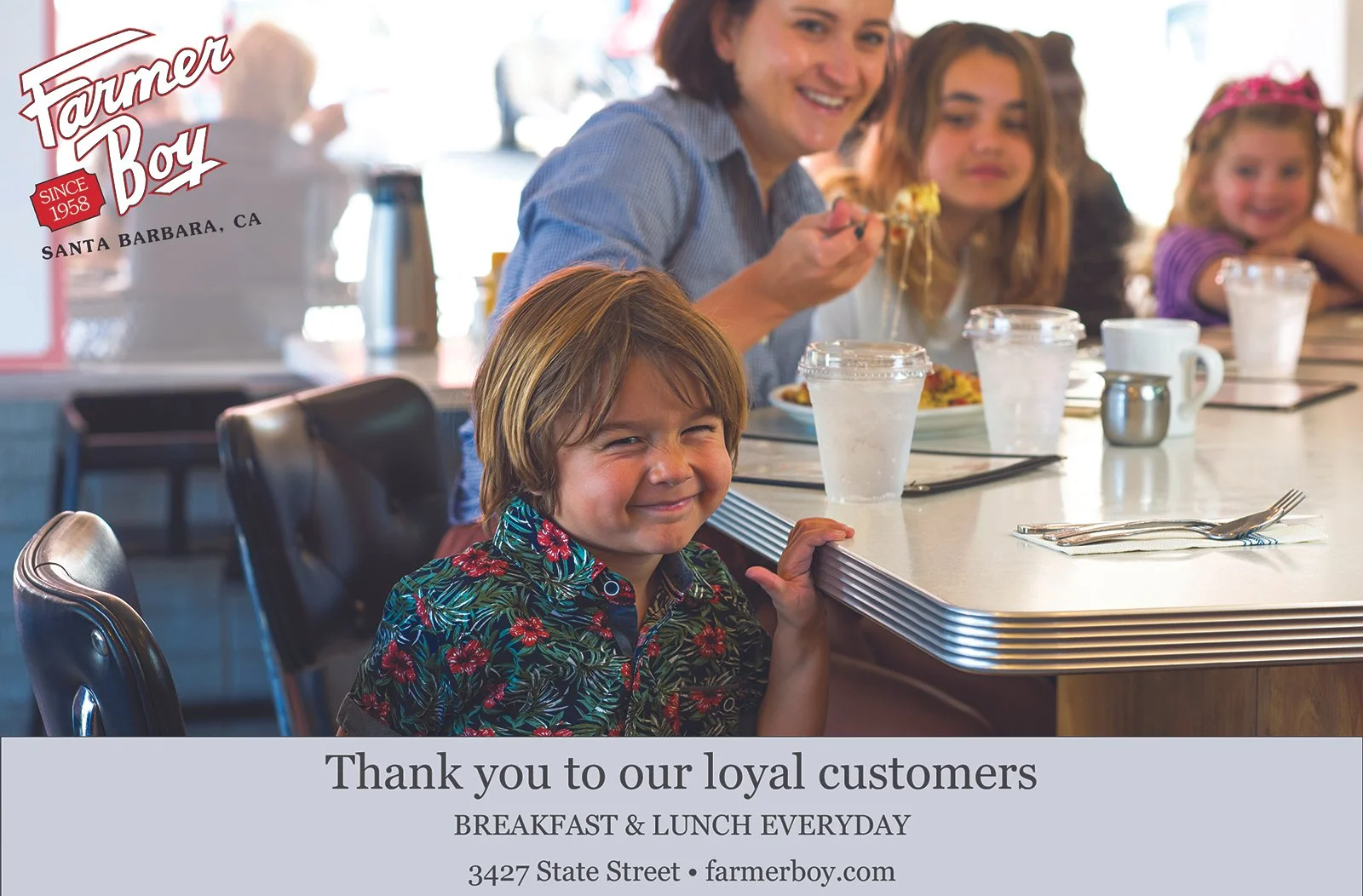 Young boy smiles while waiting for breakfast at the Farmer Boy Diner counter