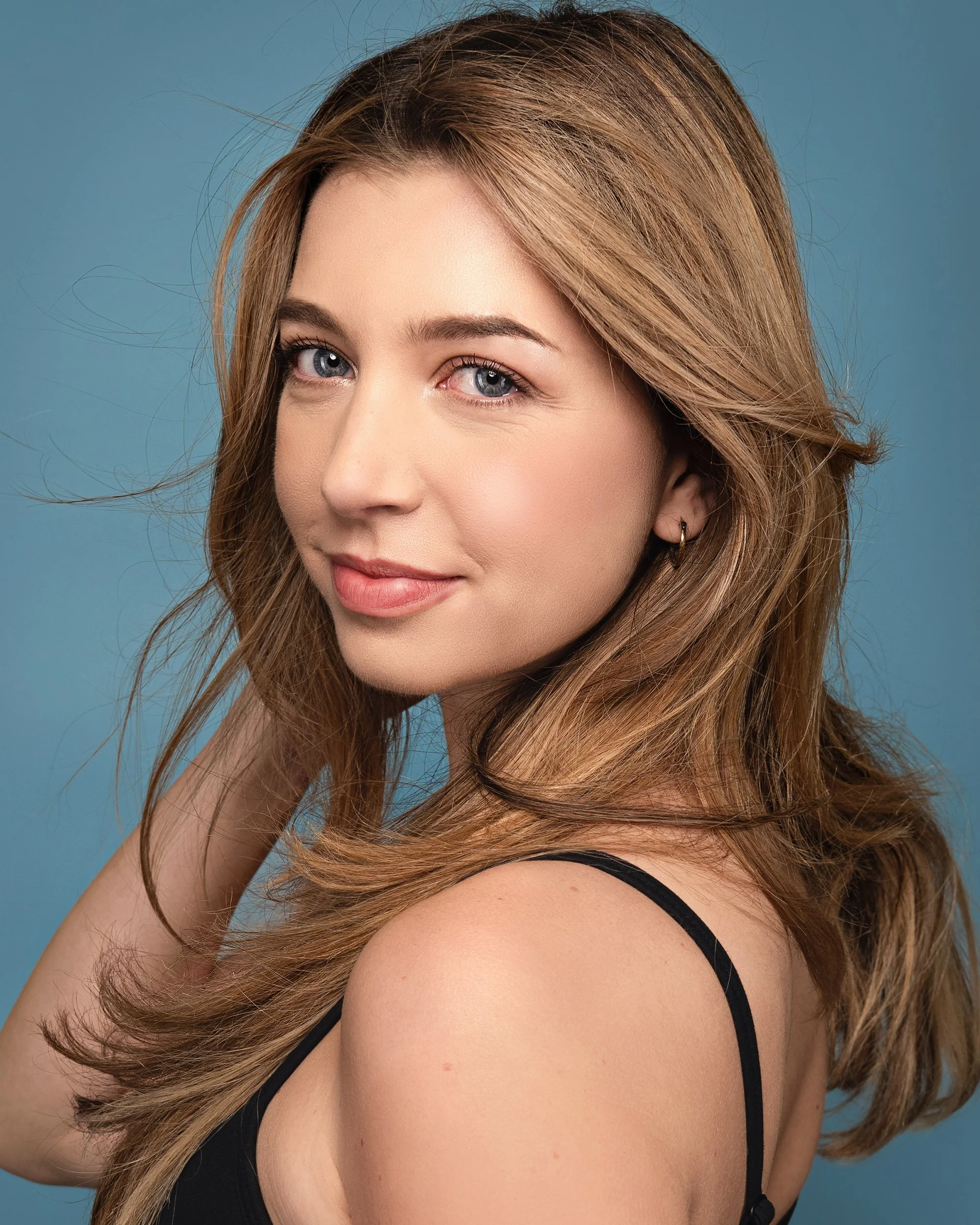 Colored backdrop and studio lighting for female headshots.