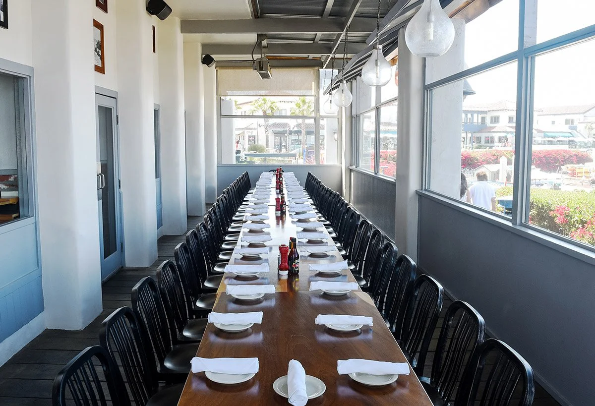 eLong table perspective with harbor views at On the Alley Ventura