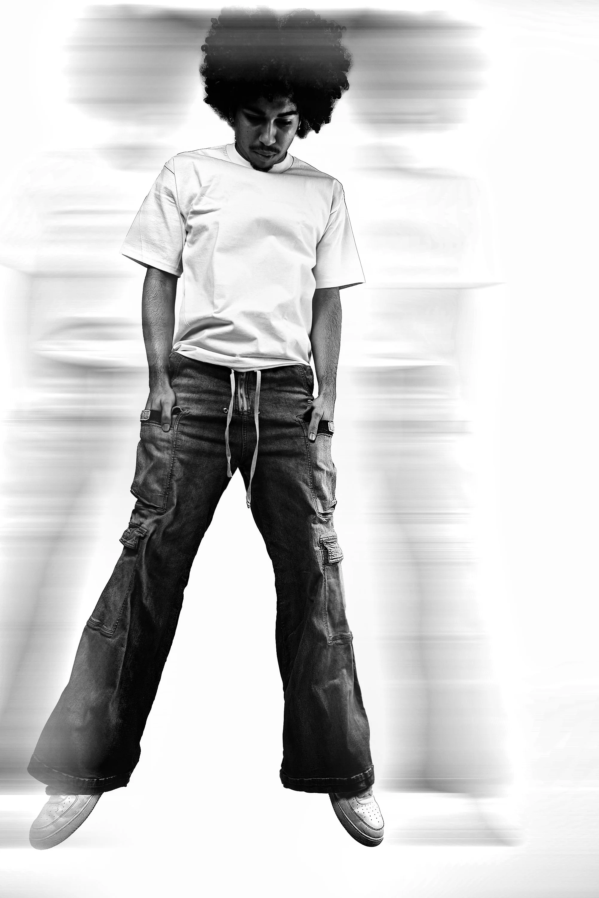 Studio effects of young man jumping in jeans.