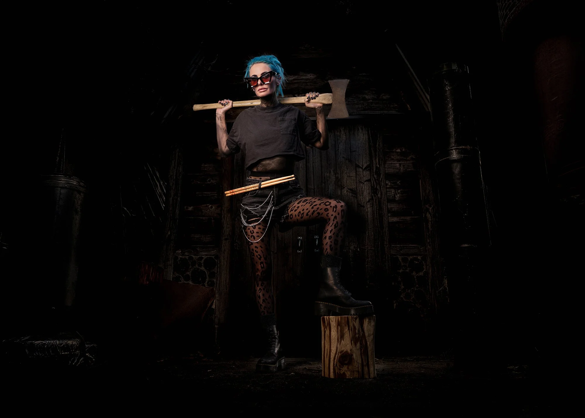 Striking portrait of female death metal drummer with blue hair from Too Sick Too Pray.