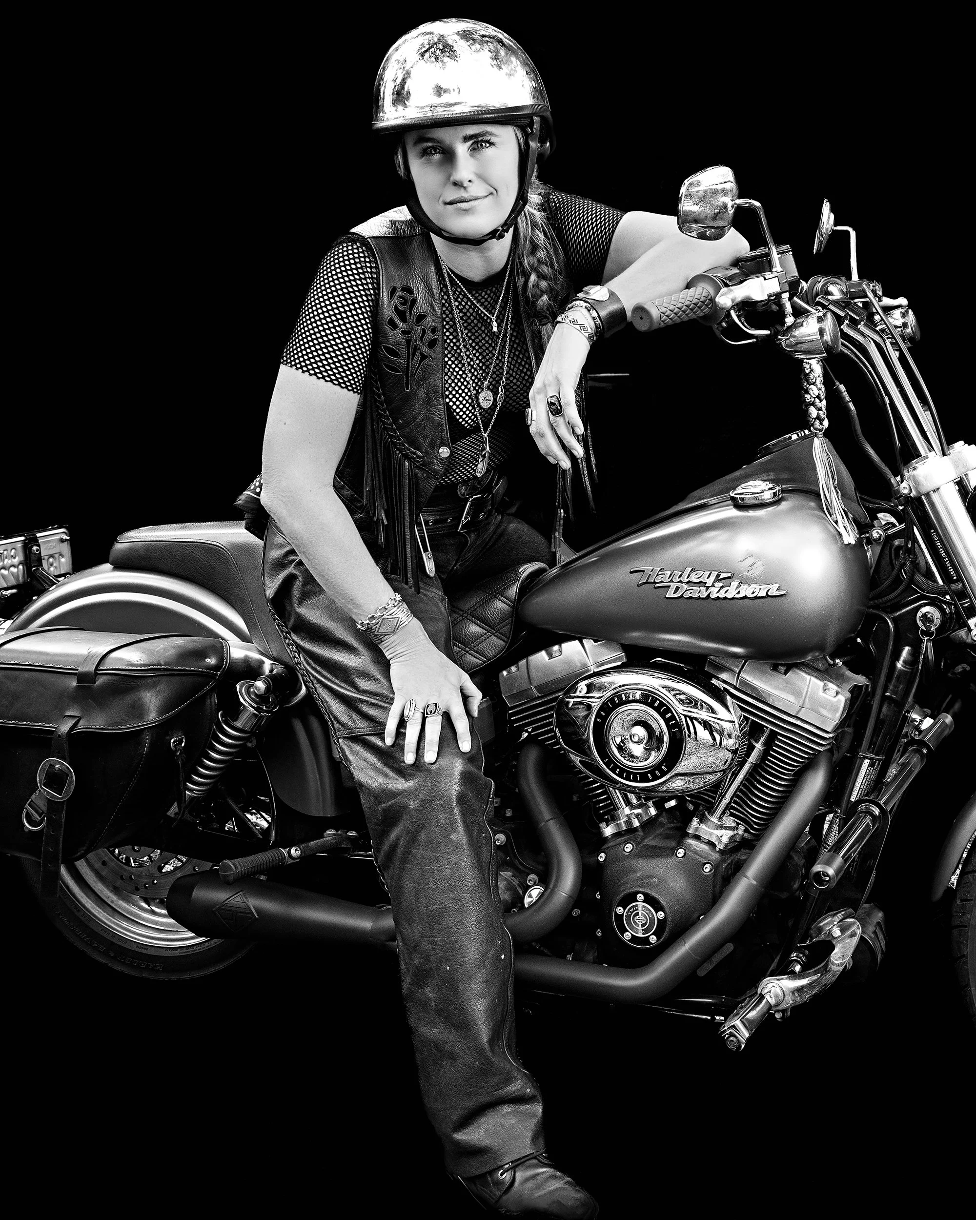 Black and white portrait of female rider in her gear