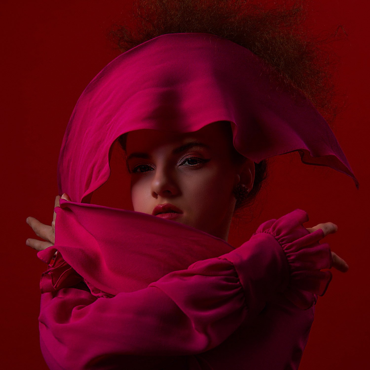 model wraps her head in fuchsia scarf