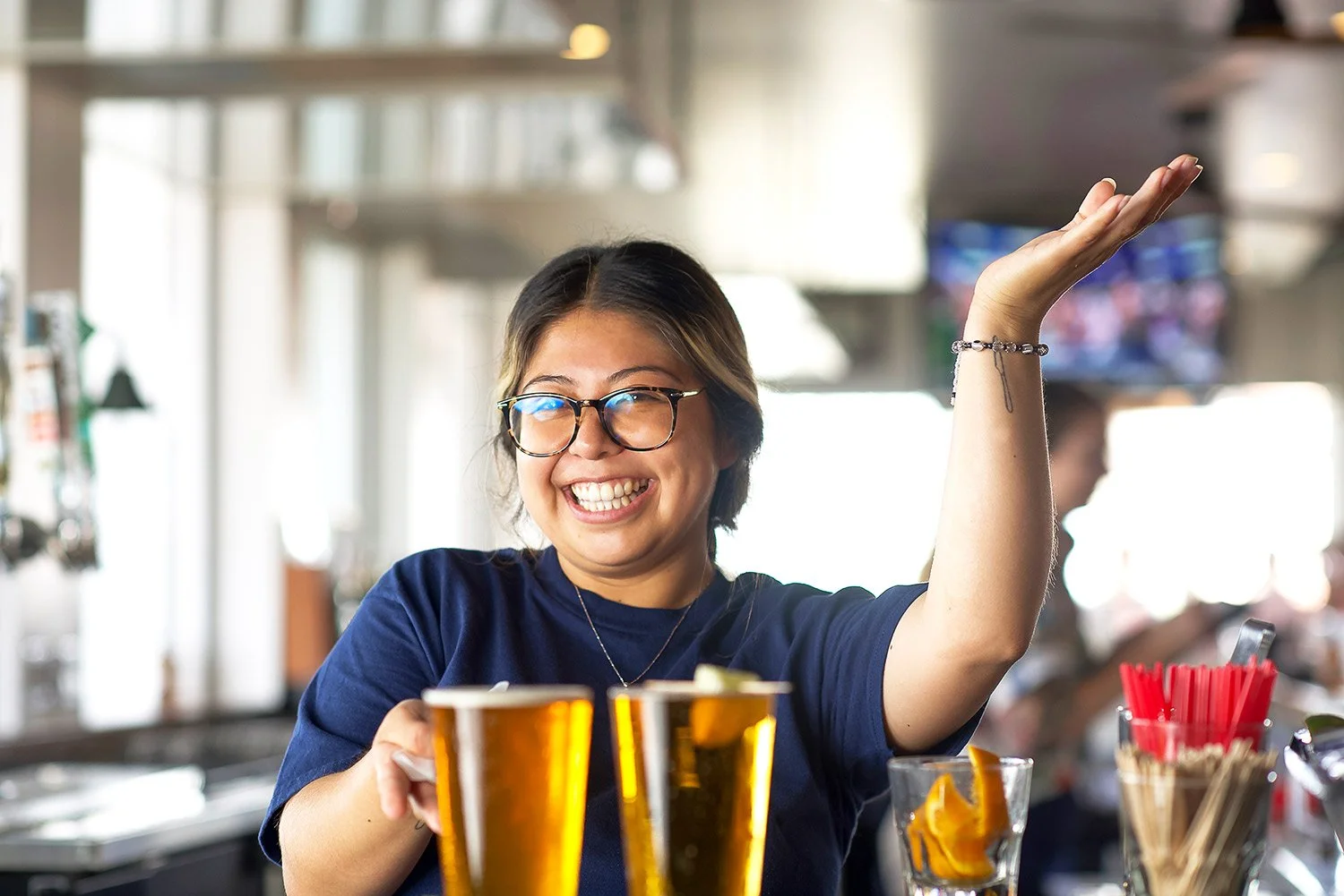 a smiling server greets mew guests