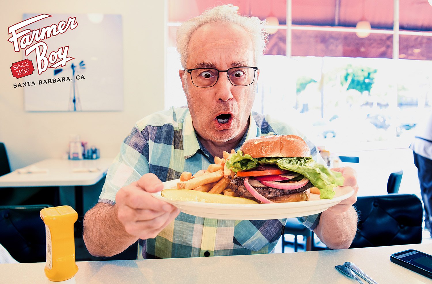 surprised by the large portions a man inspects his burger