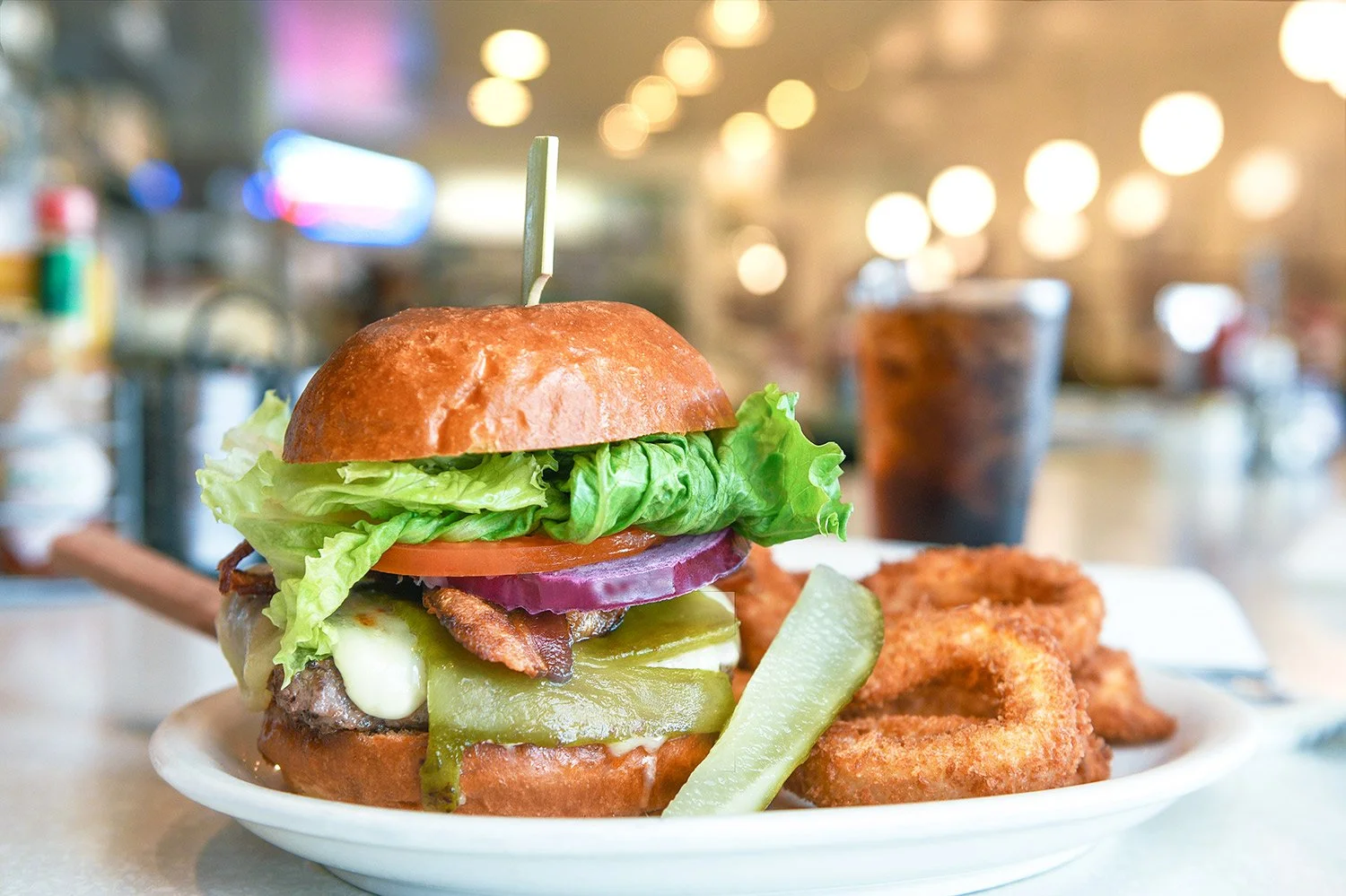 Farmer boy breakfast burger and beverage sit on the counter