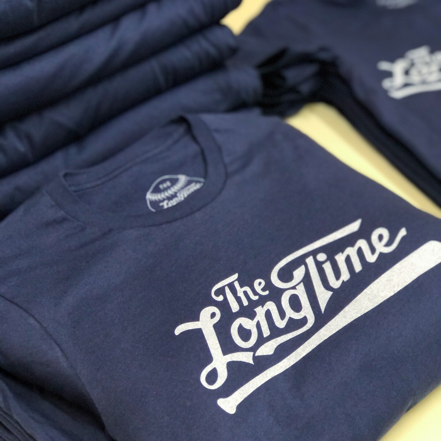 Vintage white ink on navy and custom tag printing 😎  Visit our website to request a quote!