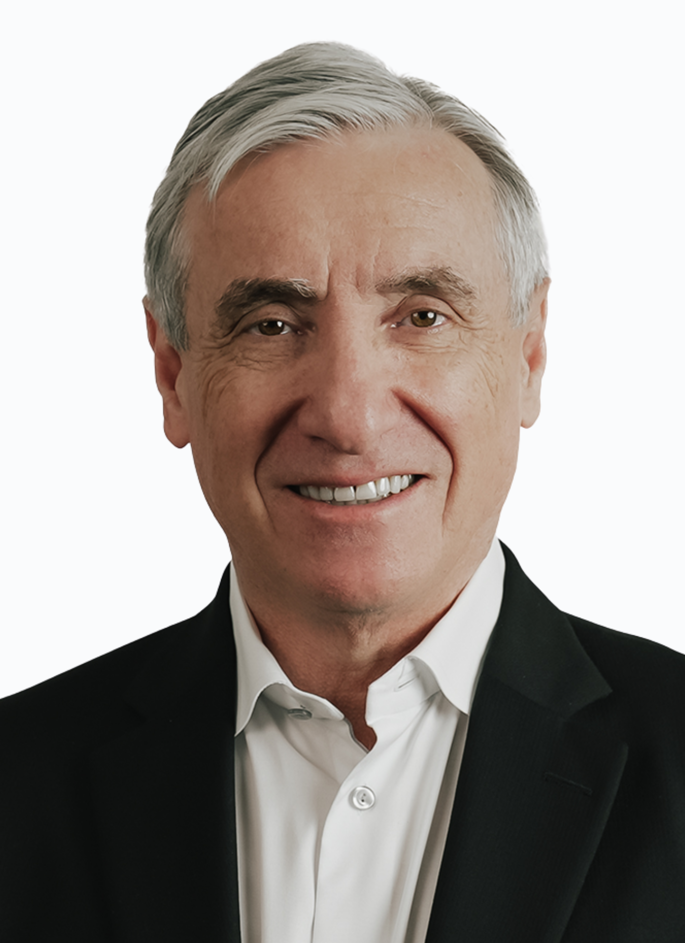 Headshot of an older man with silver hair, wearing a black suit and white shirt, smiling at the camera.