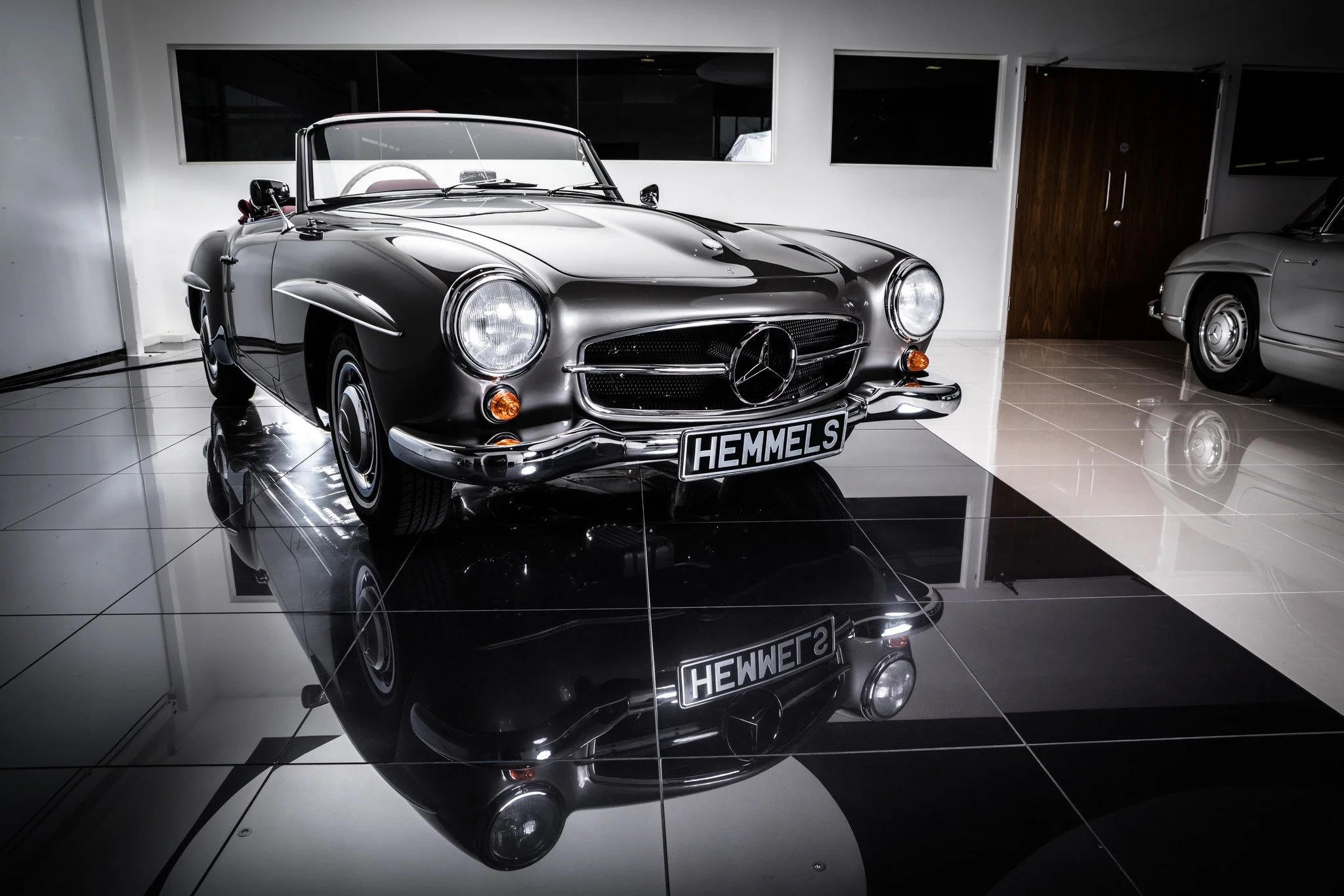A 190SL poses confidently as its inspirational predecessor,  the 300SL, is just out of frame. Whichever classic SL you desire, Hemmels can make your dreams a reality.