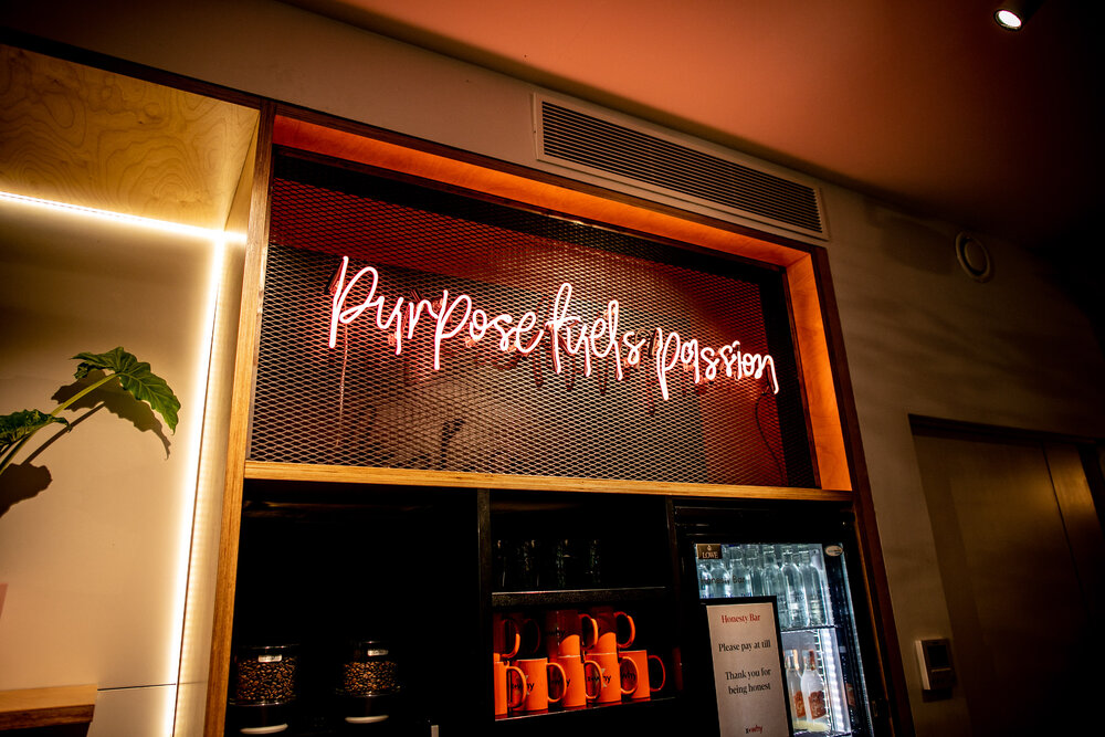 Purpose fuels passion sign at X+Why | Book workspace by the day via Tally Market