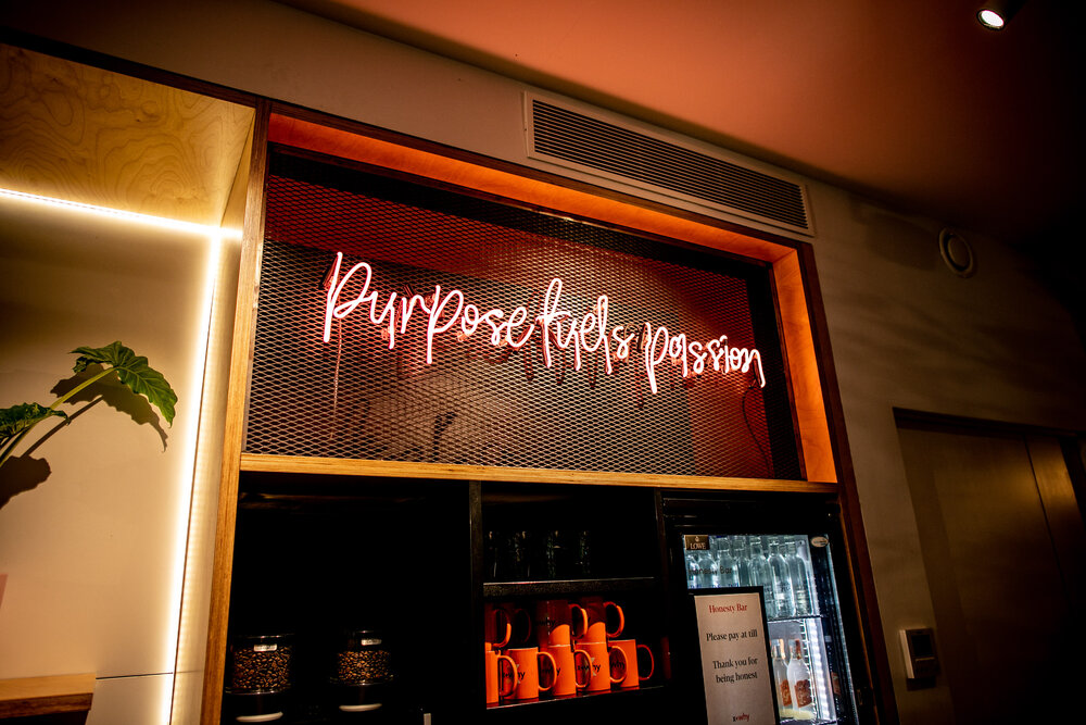 Purpose fuels passion sign at X+Why | Book workspace by the day via Tally Workspace