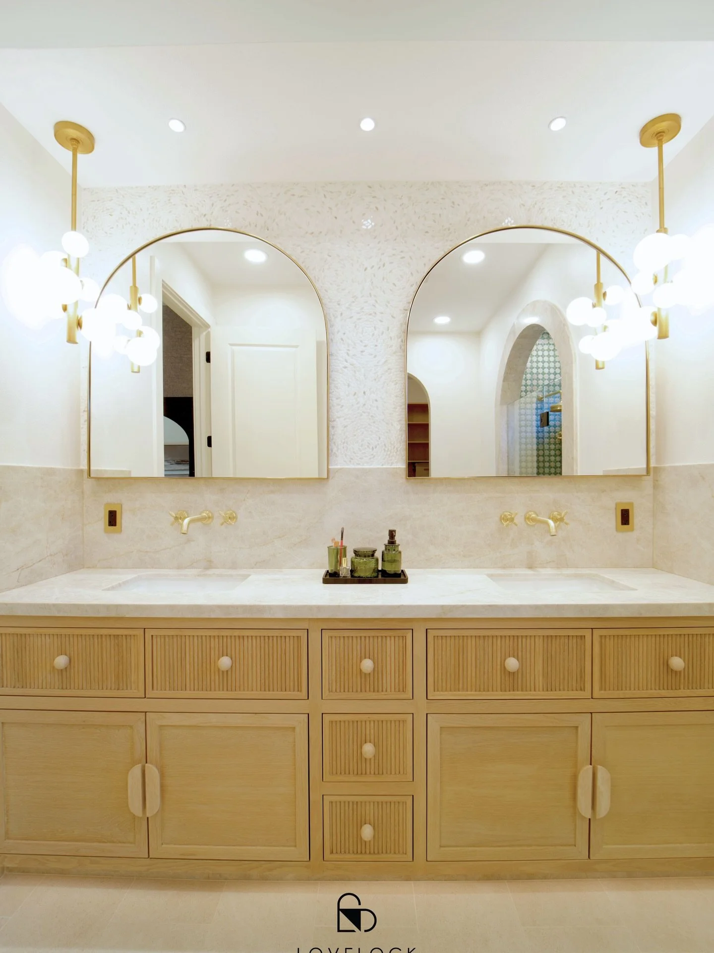 We had such a great time designing this space it&rsquo;s one of those bathrooms that just feels good to be in. The light wood double vanity really grounds the room, and the subtle reeded details and soft hardware add just the right amount of texture.