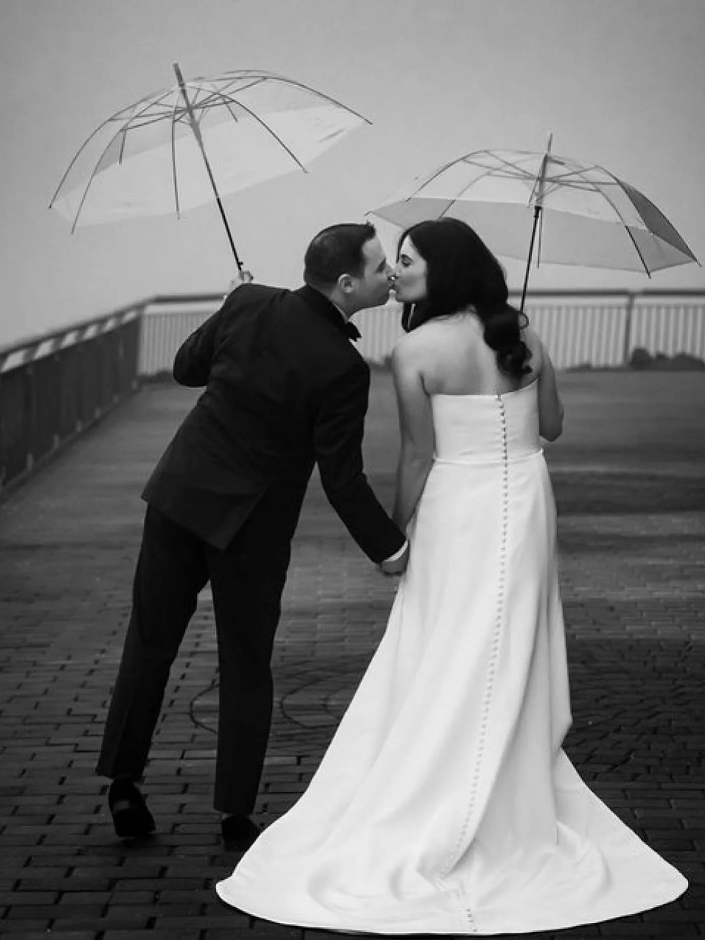 Proof that a little rain makes the best backdrop. Randi &amp; Max, effortlessly timeless.

Bride and Groom: @randi.hecht @maxhecht1 
Planning: @fabridalstyling 
Hair: @hair_by_laurenr 
Makeup: @brianbmuphair 
Floral: @konstantinosfloraldesign 
Band: 
