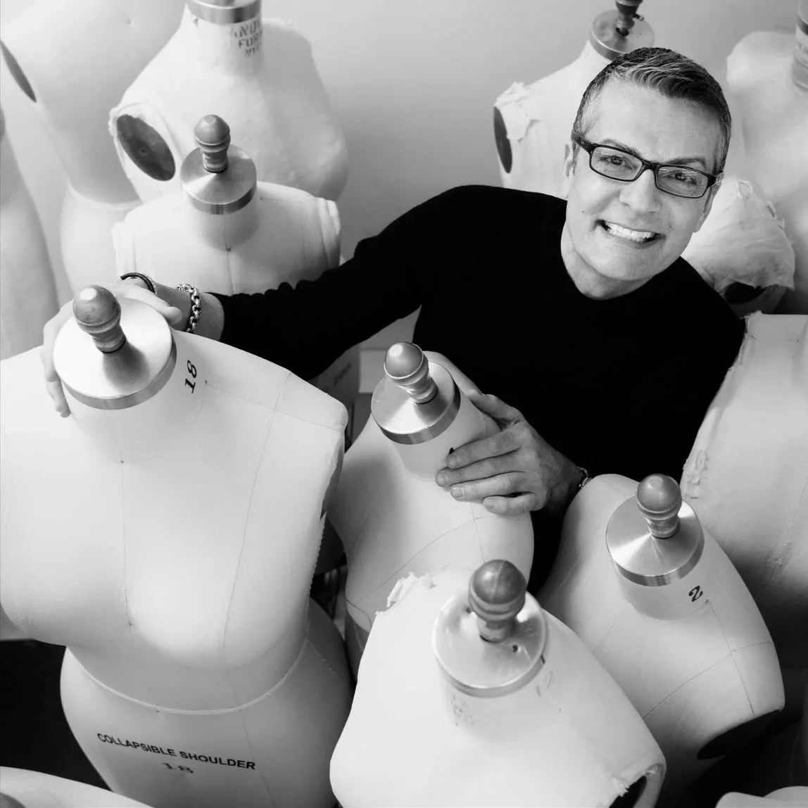 In a room full of silhouettes, one presence commands the light.⁠
Randy Fenoli, framed by form and fabric &mdash; style in still life.