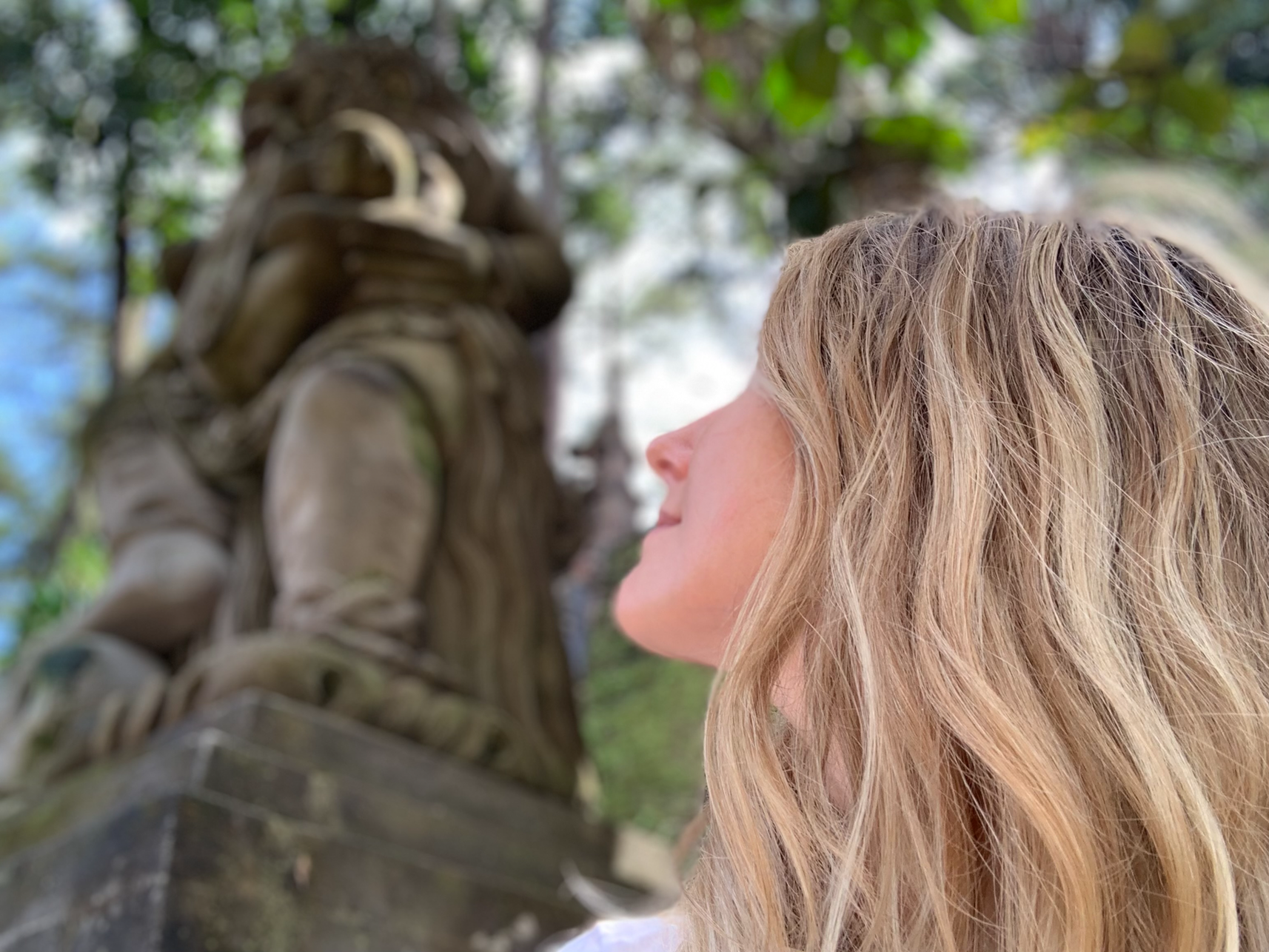 rebecca michelle, meditation coach looking up and away at a spiritual statue