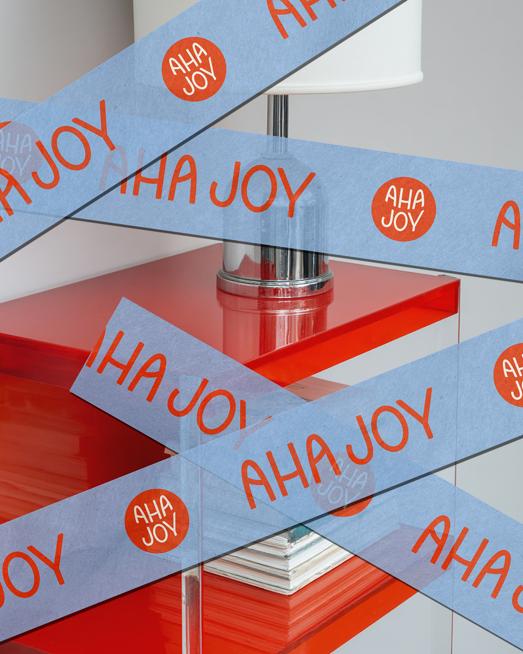 Custom blue and red packaging tap with "AhaJoy" logos stamped across it