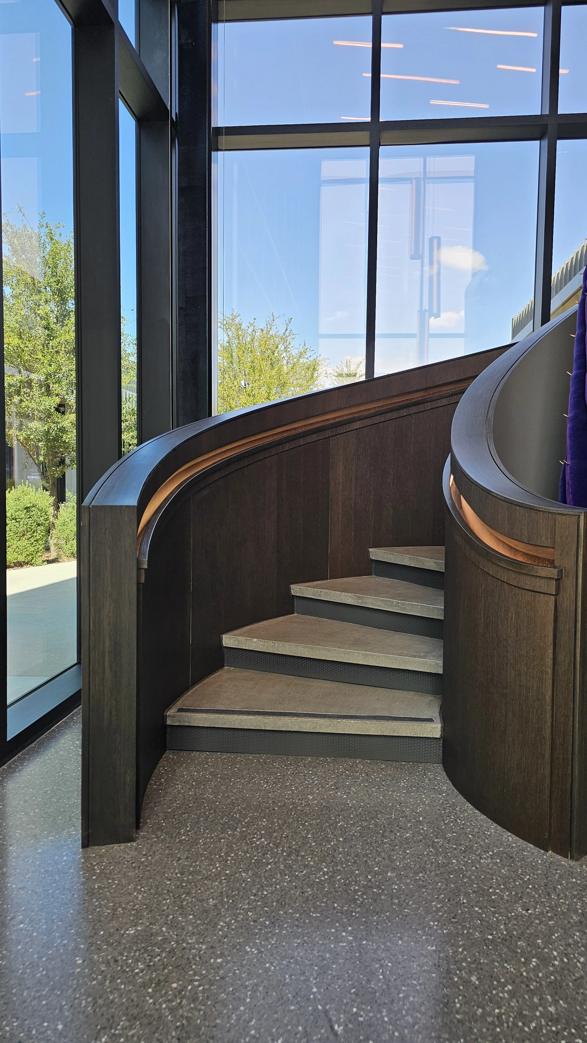 Epic Floating S Curved Lobby Stair - Stained White Oak - Concrete - Inset handrails