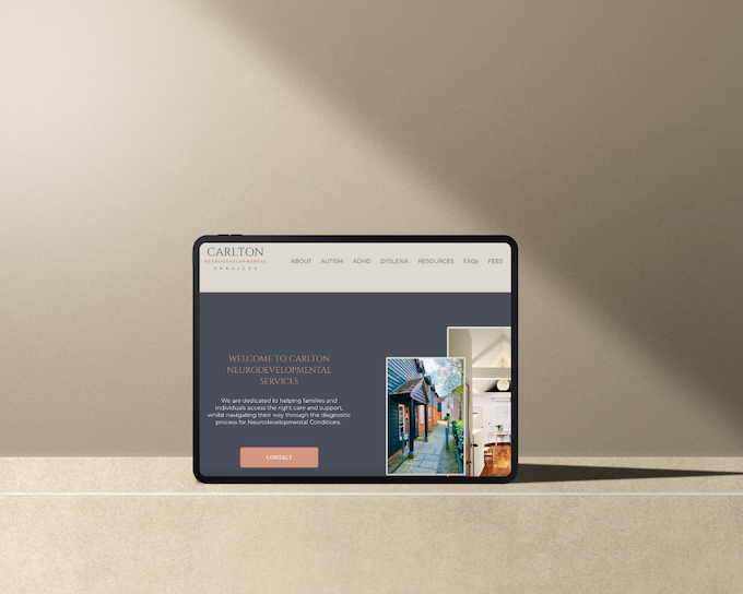 Tablet displaying the Carlton Neurodevelopmental Services website, showing services related to autism, ADHD, and dyslexia.