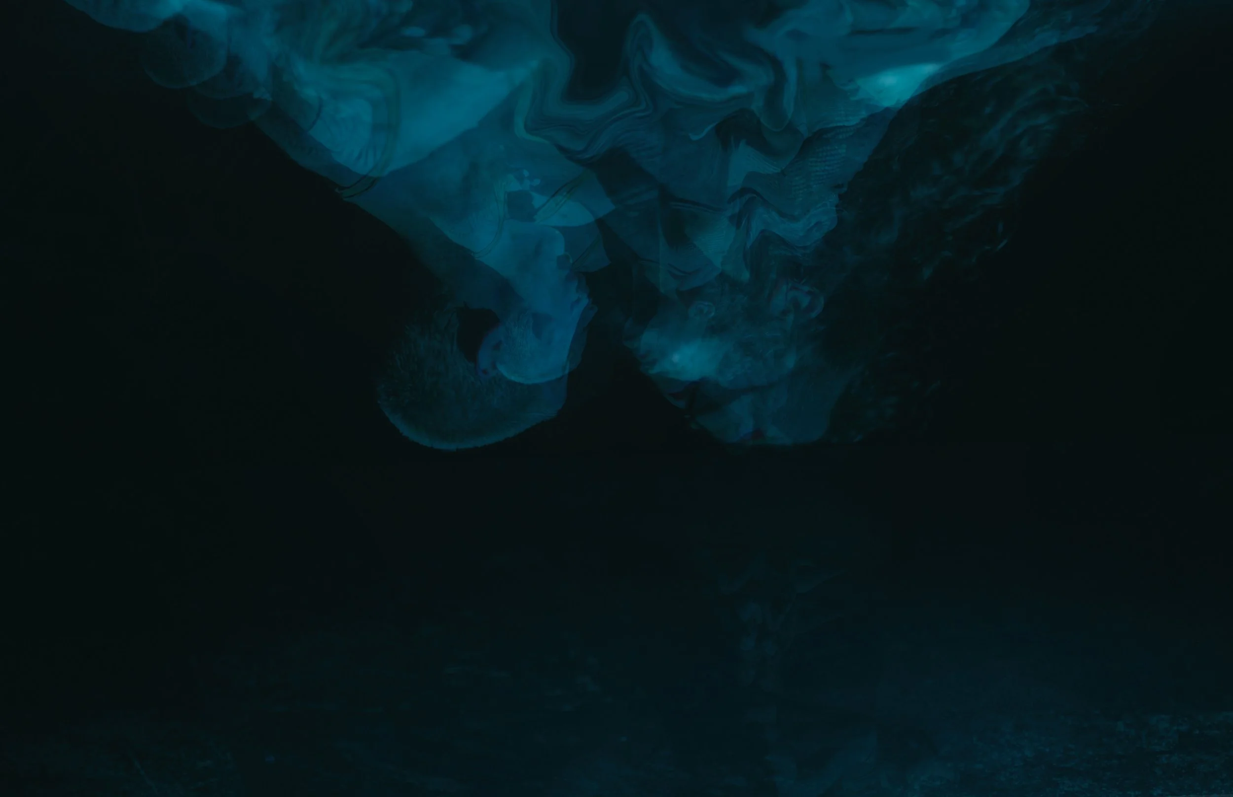 A plume of blue smoke hovers against a black backdrop