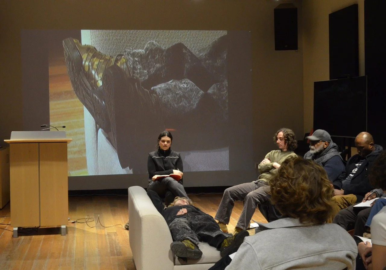 A mock group therapy session with live projections in the background.