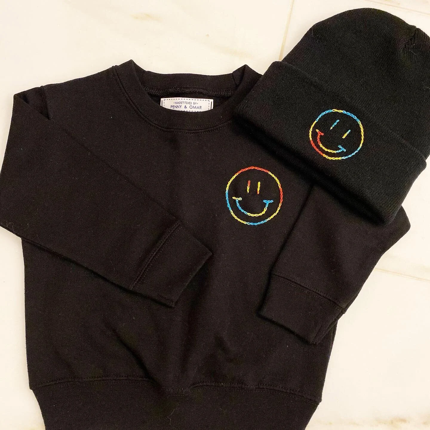 Mommy &amp; Me has never looked better 🌈🙂
.
.
.
.
.
#mommyandme #custom #embroidery #matching #matchingoutfits #momlife #toddlerlife #giftideas #smiley #tiedye #gifts #baby #mommyandmephotoshoot #mommyandmefashion #handmade #stitched #beanie #sweat