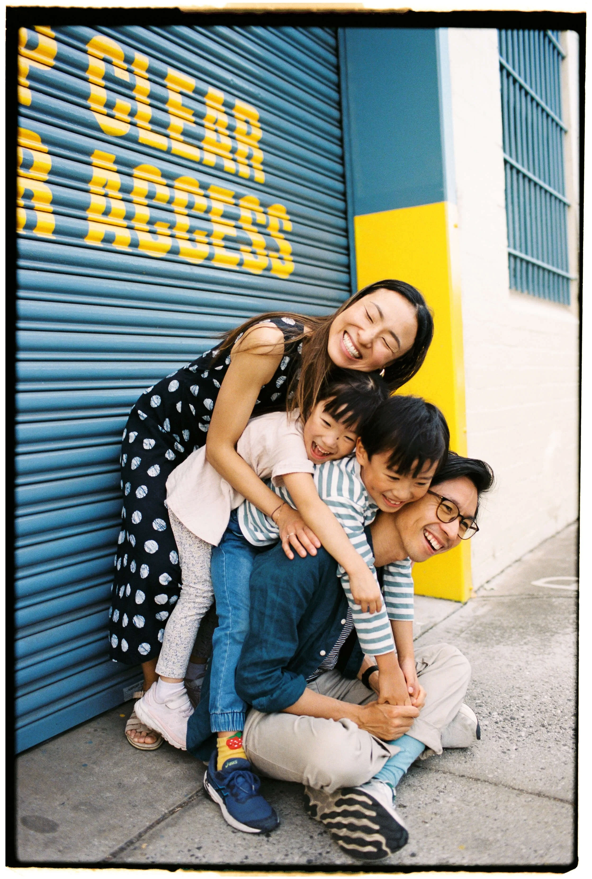 Jonathan Ong and his family laugh together in a candid family photograph outside an ice cream shop.