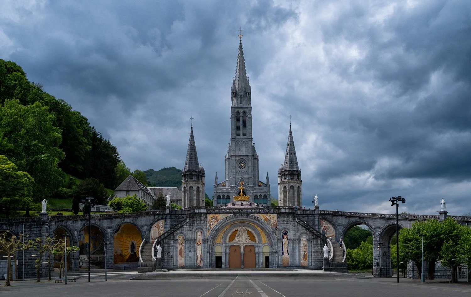 pilgrimage in the city of lourdes france dedicated to Lady Virgin Mary also known as Immaculate Conception who gave apparition to St. Bernadette featuring sanctuary church basilica grotto cave miraculous water and Marian procession