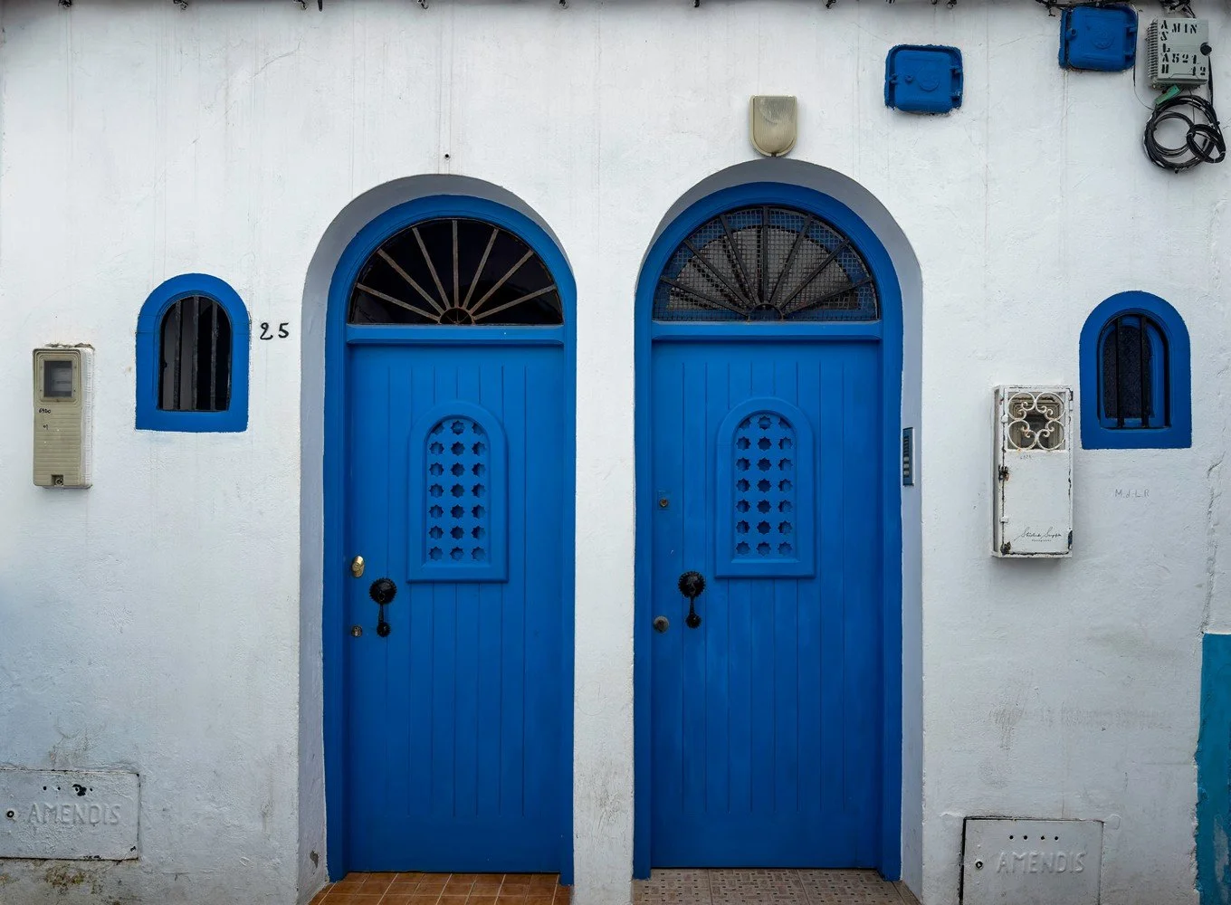 asilah in morocco africa featuring blue medina with painted doors windows street art graffiti mural krikia viewpoint raissouni palace alqamra tower and Grand Mosque