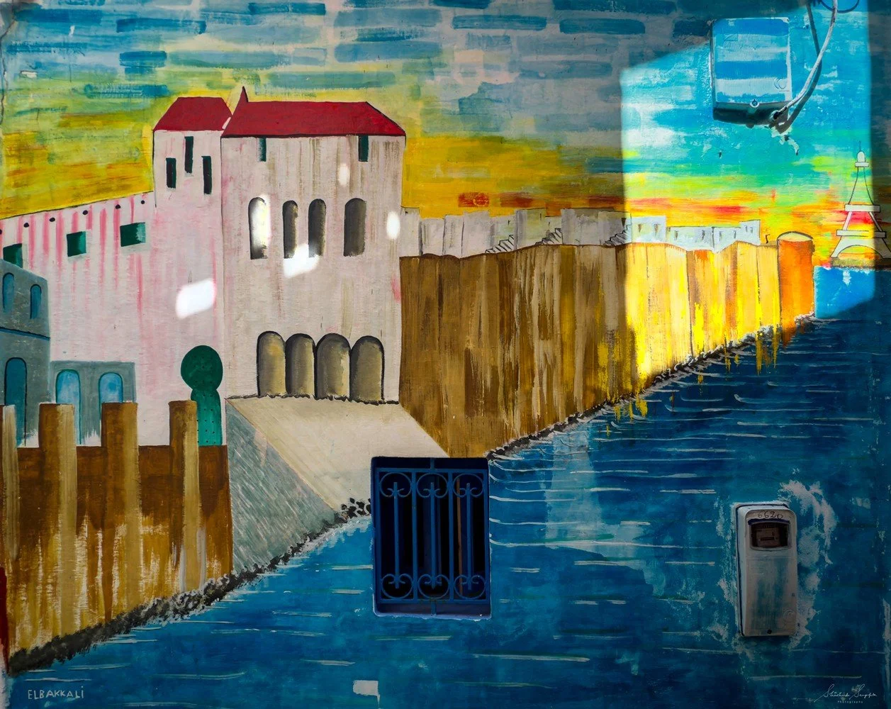 asilah in morocco africa featuring blue medina with painted doors windows street art graffiti mural krikia viewpoint raissouni palace alqamra tower and Grand Mosque
