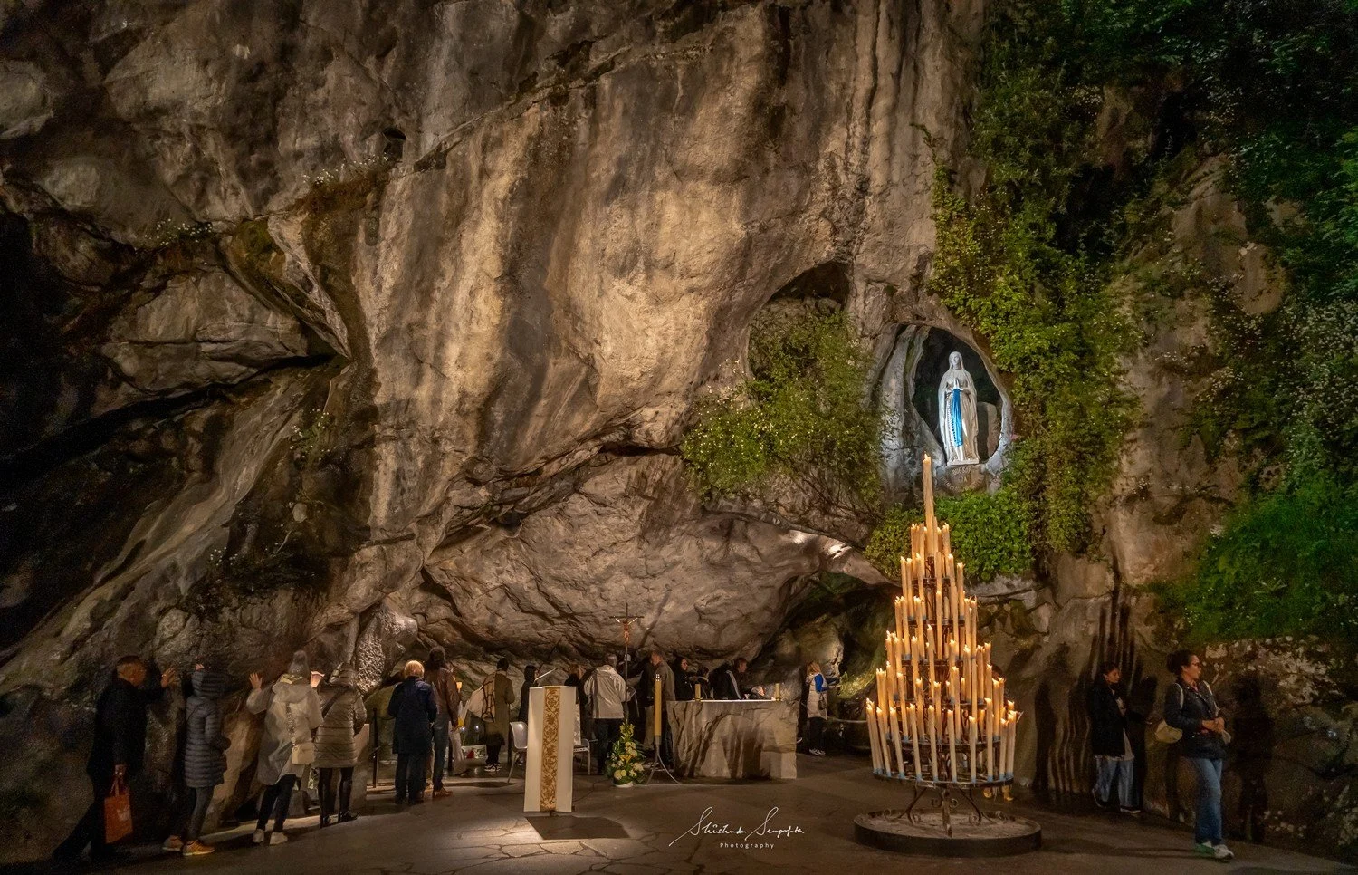 pilgrimage in the city of lourdes france dedicated to Lady Virgin Mary also known as Immaculate Conception who gave apparition to St. Bernadette featuring sanctuary church basilica grotto cave miraculous water and Marian procession