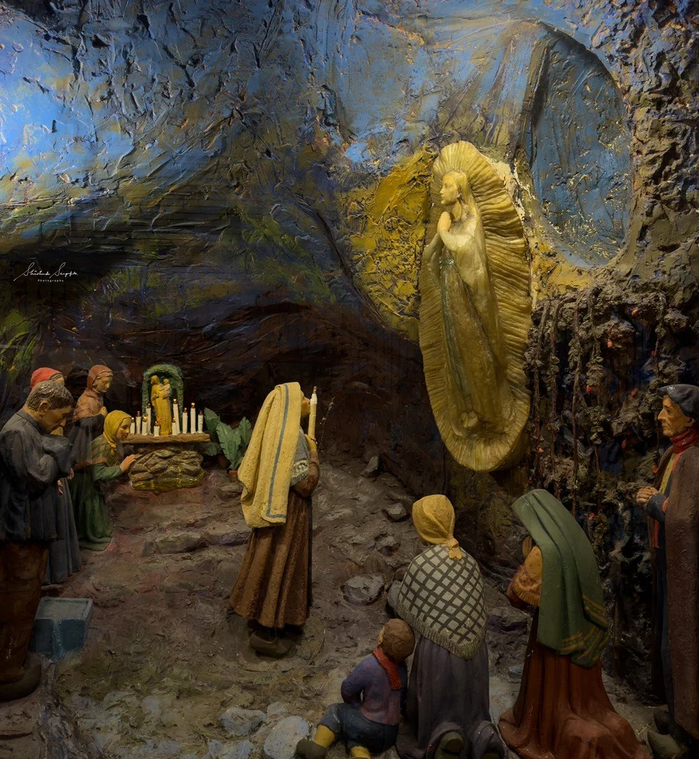 pilgrimage in the city of lourdes france dedicated to Lady Virgin Mary also known as Immaculate Conception who gave apparition to St. Bernadette featuring sanctuary church basilica grotto cave miraculous water and Marian procession