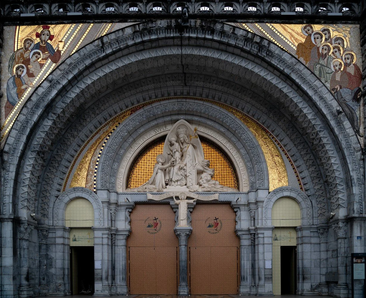 pilgrimage in the city of lourdes france dedicated to Lady Virgin Mary also known as Immaculate Conception who gave apparition to St. Bernadette featuring sanctuary church basilica grotto cave miraculous water and Marian procession