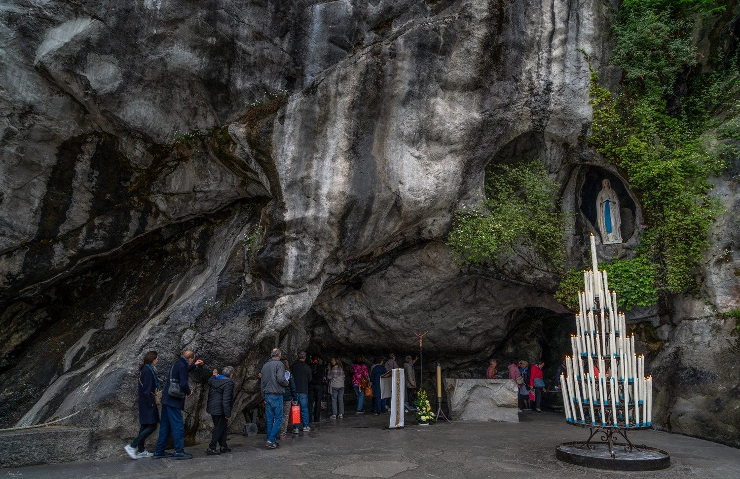 pilgrimage in the city of lourdes france dedicated to Lady Virgin Mary also known as Immaculate Conception who gave apparition to St. Bernadette featuring sanctuary church basilica grotto cave miraculous water and Marian procession