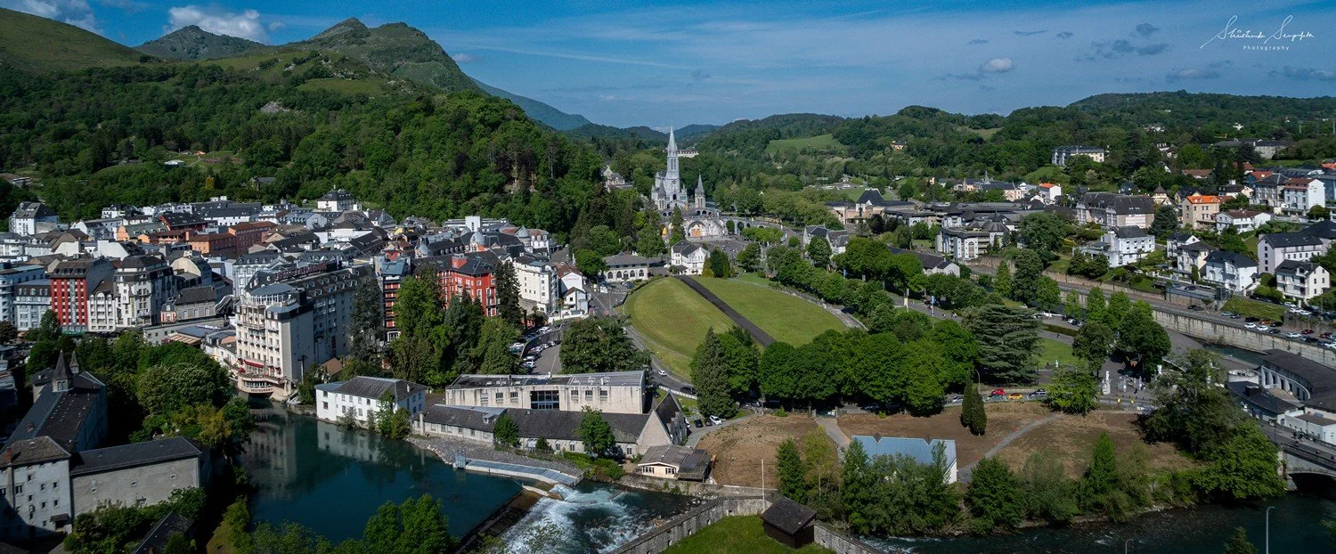 pilgrimage in the city of lourdes france dedicated to Lady Virgin Mary also known as Immaculate Conception who gave apparition to St. Bernadette featuring sanctuary church basilica grotto cave miraculous water and Marian procession