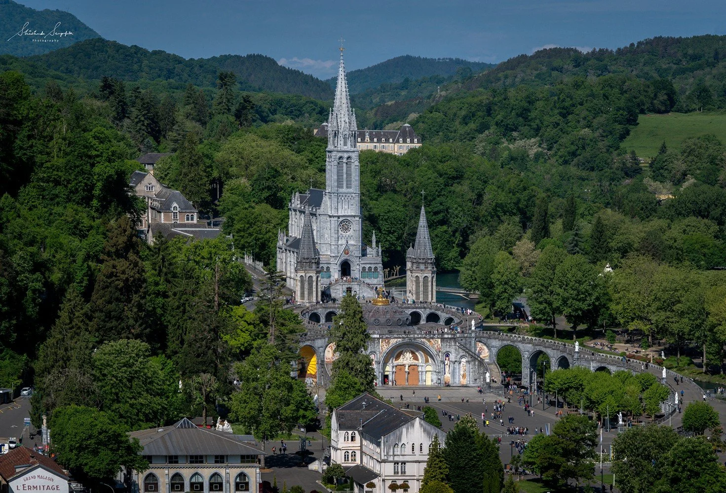 pilgrimage in the city of lourdes france dedicated to Lady Virgin Mary also known as Immaculate Conception who gave apparition to St. Bernadette featuring sanctuary church basilica grotto cave miraculous water and Marian procession