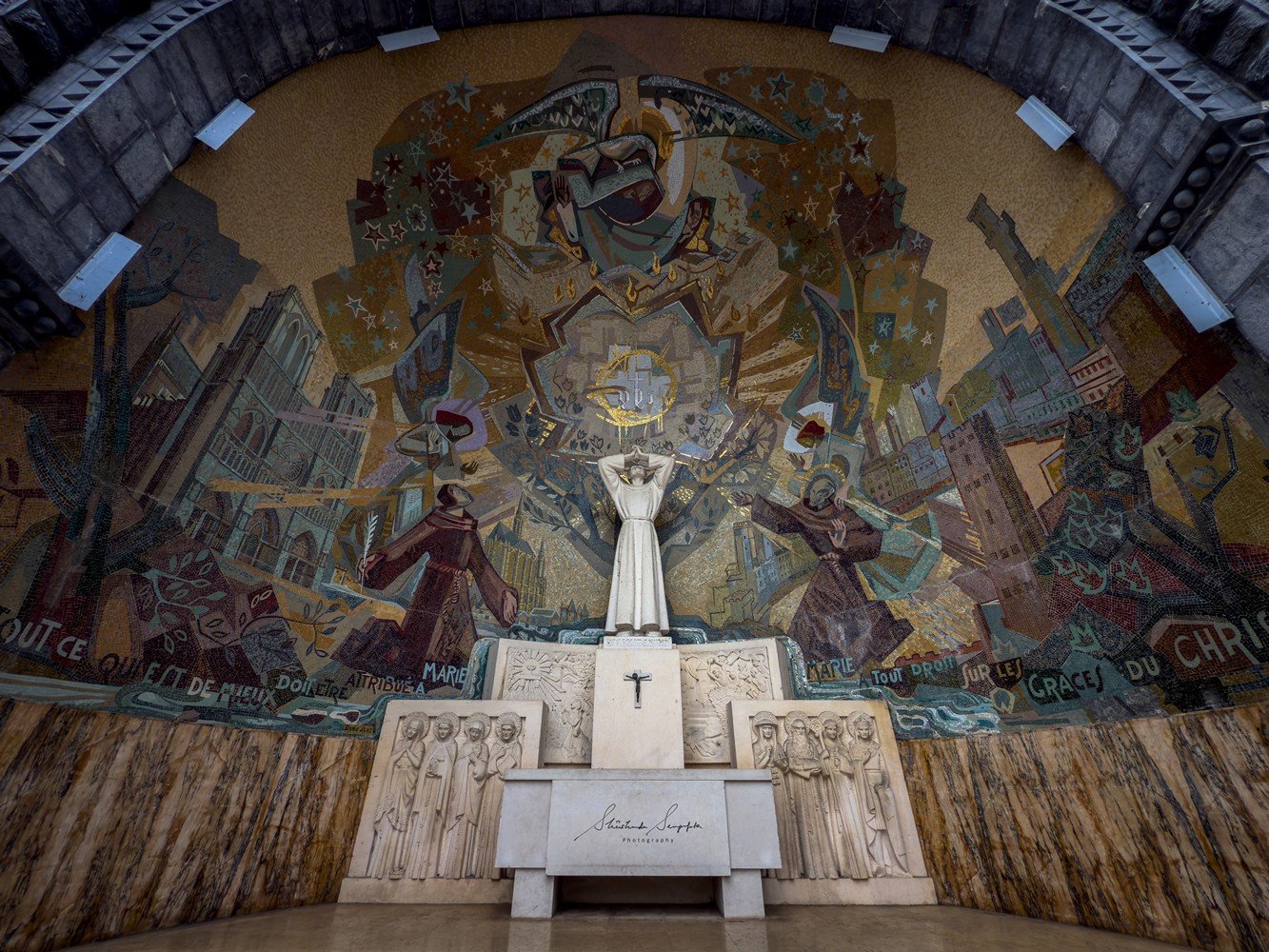 pilgrimage in the city of lourdes france dedicated to Lady Virgin Mary also known as Immaculate Conception who gave apparition to St. Bernadette featuring sanctuary church basilica grotto cave miraculous water and Marian procession