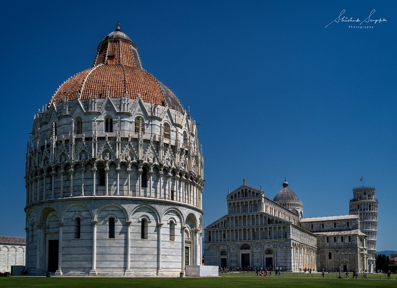 pisa baptistry cathedral and leaning clock tower in pisa tuscany italy shot in summer