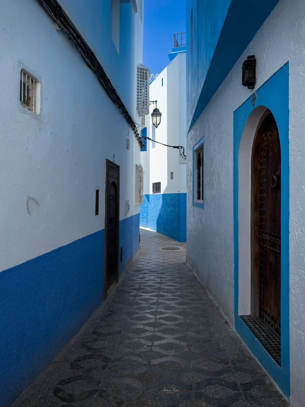 asilah in morocco africa featuring blue medina with painted doors windows street art graffiti mural krikia viewpoint raissouni palace alqamra tower and Grand Mosque