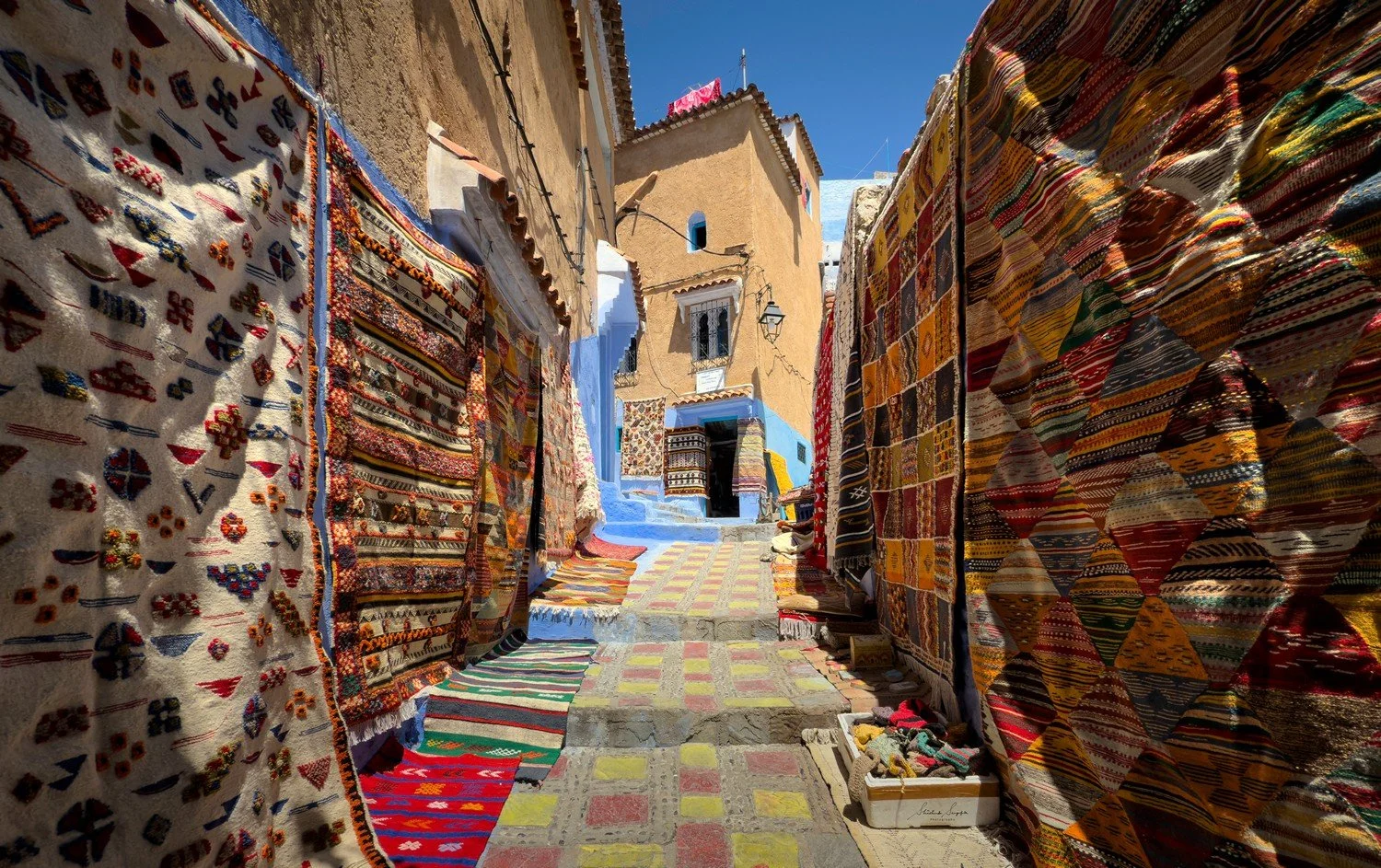 blue city of chefchaouen in morocco africa featuring blue medina alleyways place El Haouta plaza uta el hammam kasbah museum and sunset shot from bouzafer or spanish mosque
