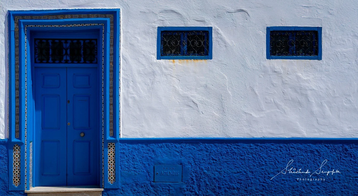 asilah in morocco africa featuring blue medina with painted doors windows street art graffiti mural krikia viewpoint raissouni palace alqamra tower and Grand Mosque