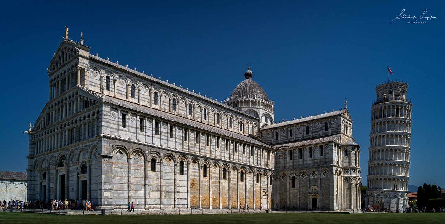 pisa baptistry cathedral and leaning clock tower in pisa tuscany italy shot in summer