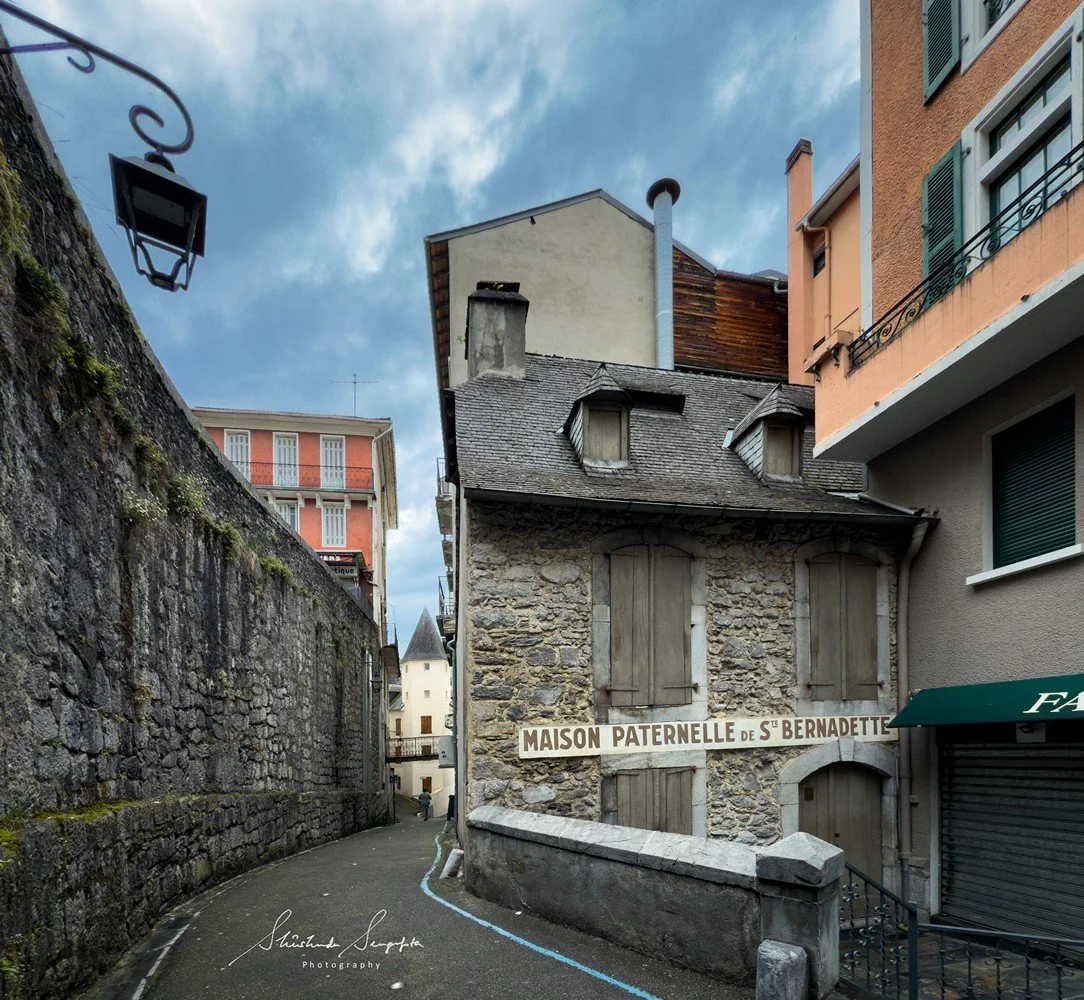 pilgrimage in the city of lourdes france dedicated to Lady Virgin Mary also known as Immaculate Conception who gave apparition to St. Bernadette featuring sanctuary church basilica grotto cave miraculous water and Marian procession